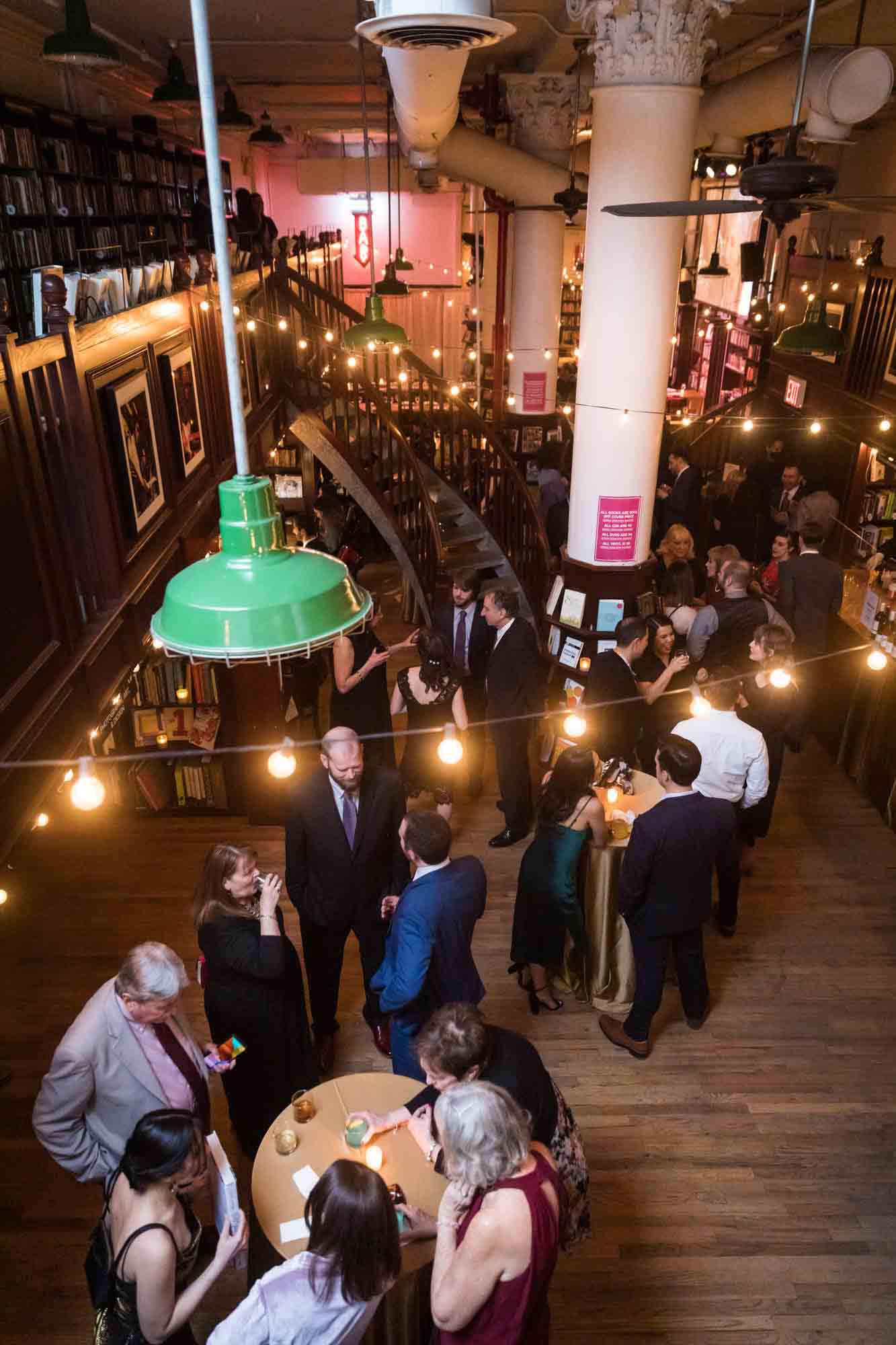 Guests enjoying reception in bookstore for an article on wedding ceremony photo tips