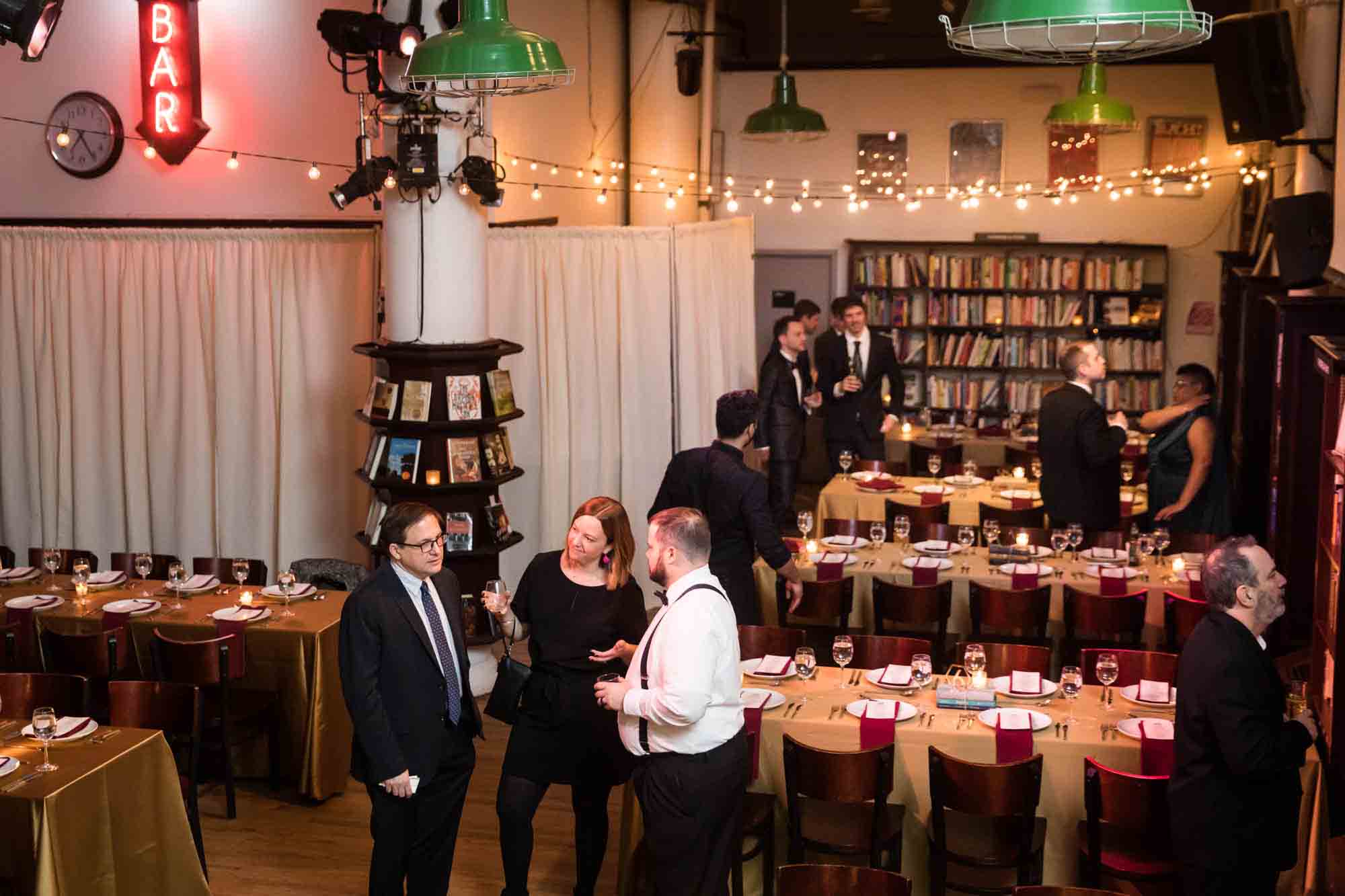 Guests enjoying reception in a bookstore at a Housing Works Bookstore wedding
