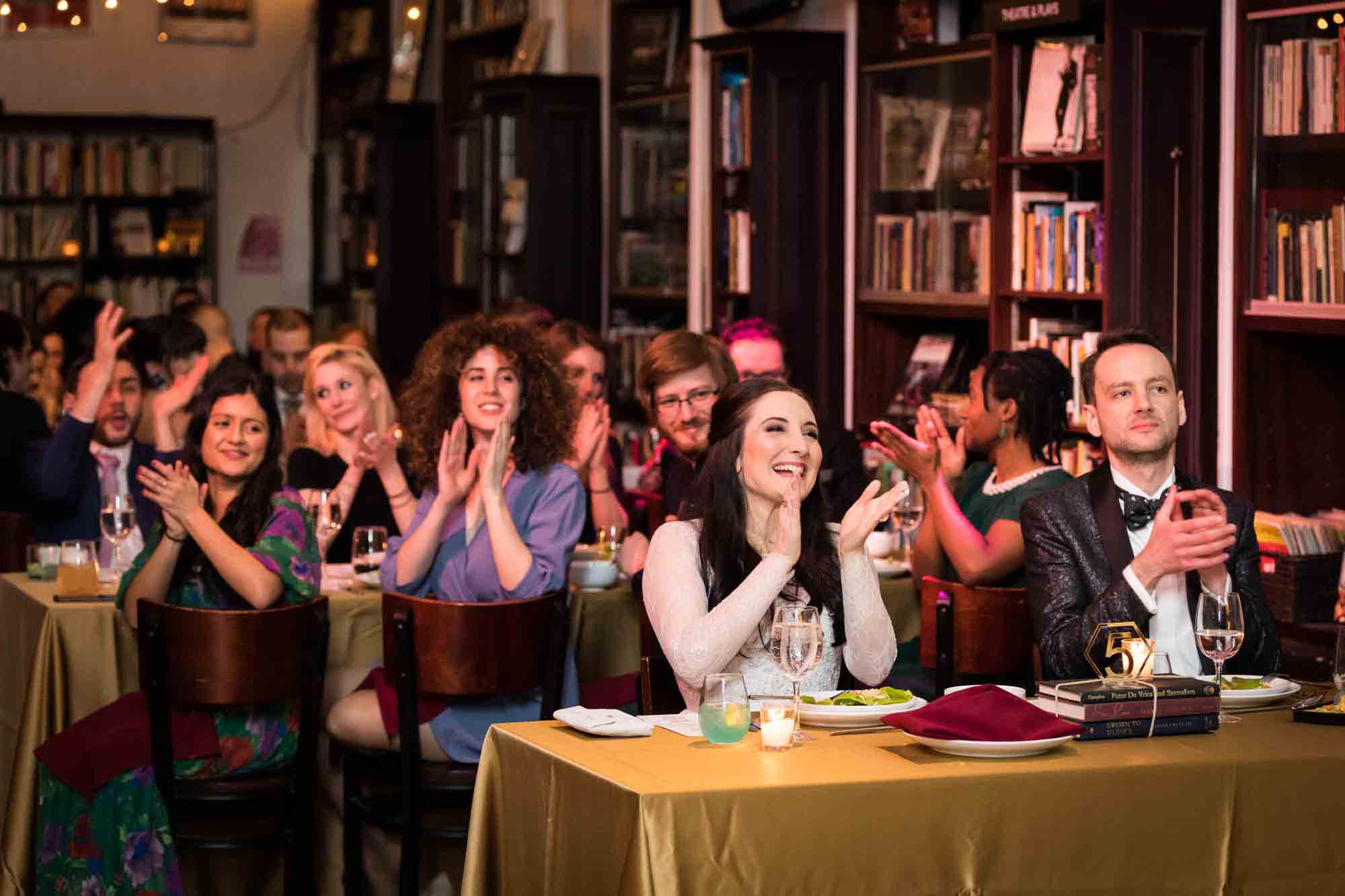 Guests clapping after toast at a Housing Works Bookstore wedding