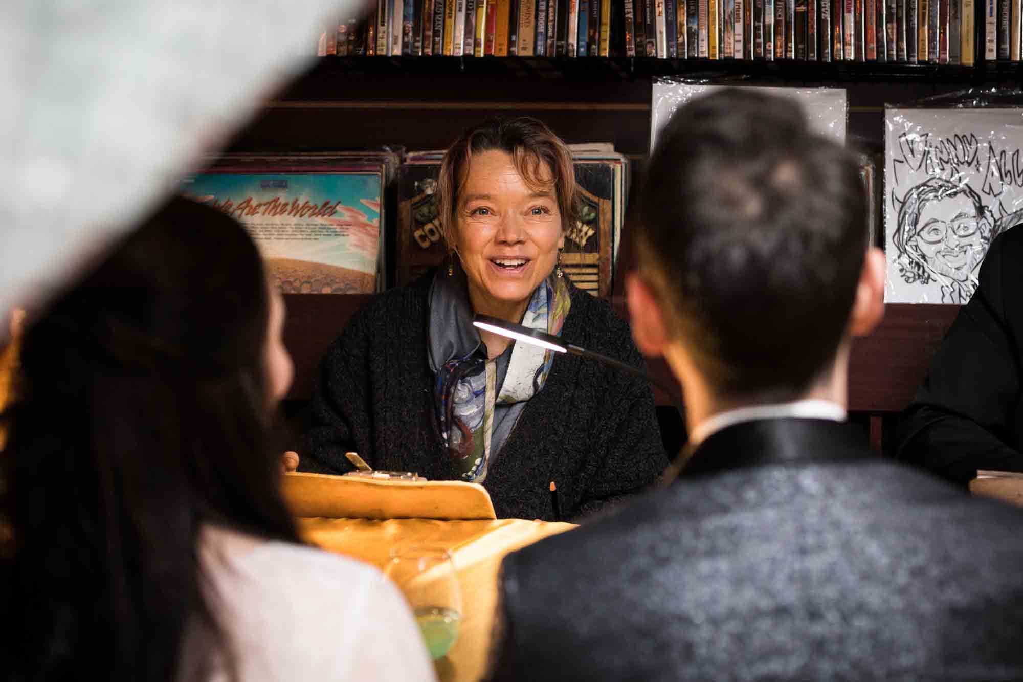 Caricature artist drawing bride and groom at a Housing Works Bookstore wedding