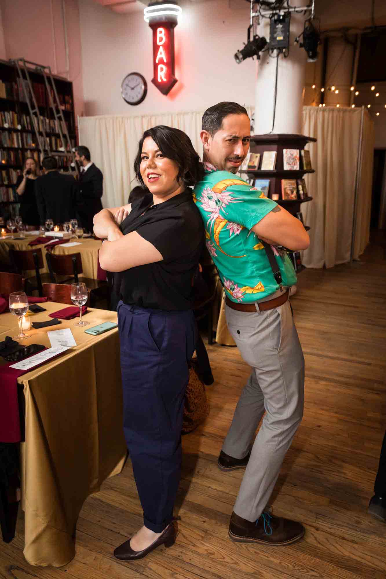 Two guests in funny back to back pose at a Housing Works Bookstore wedding