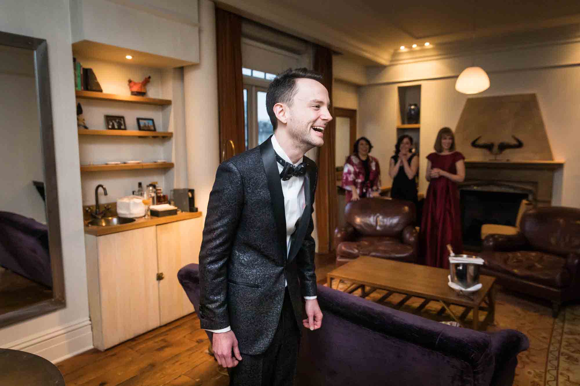 Groom with surprised look in hotel room