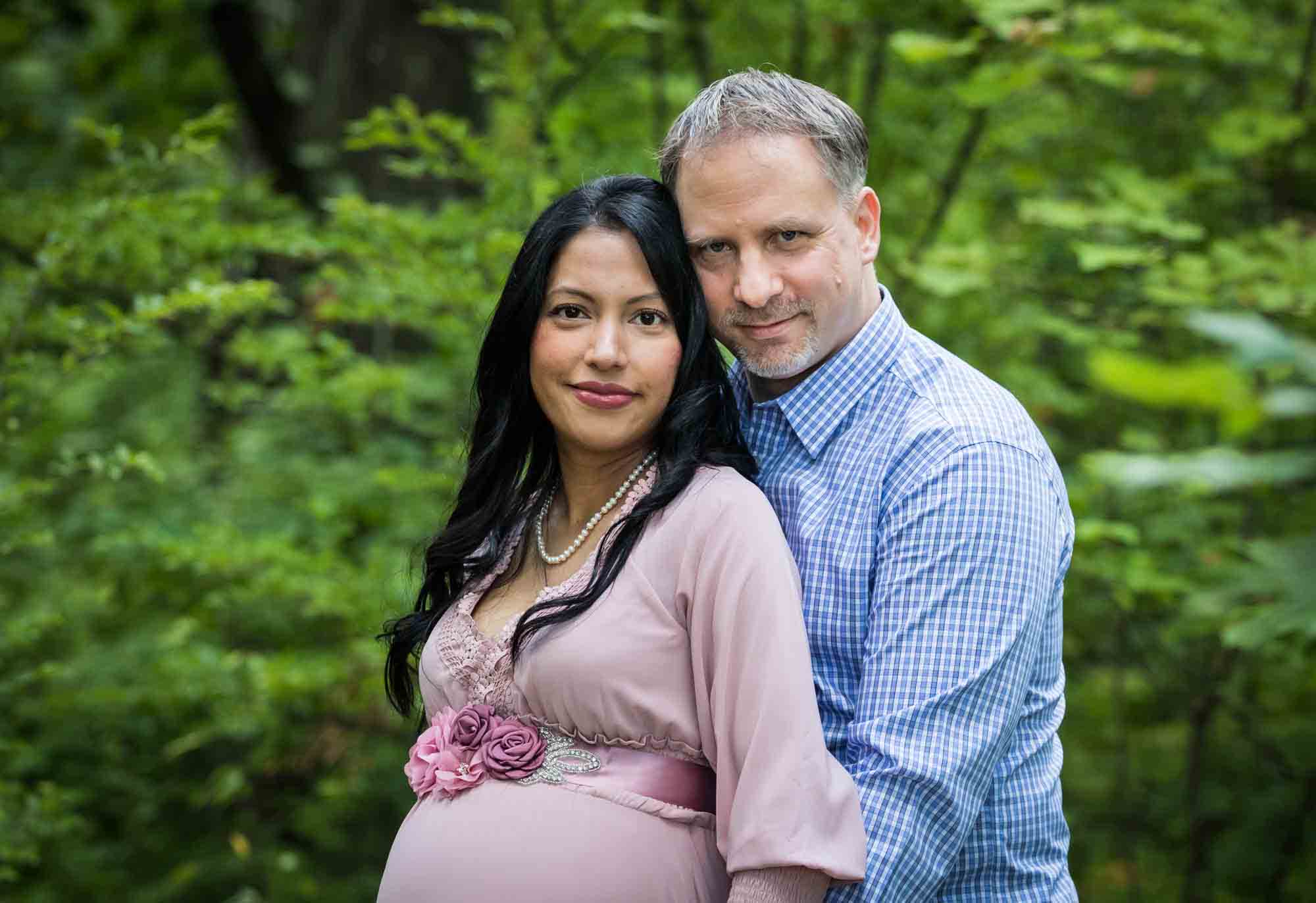 Forest Park maternity photos of a couple standing in a forest