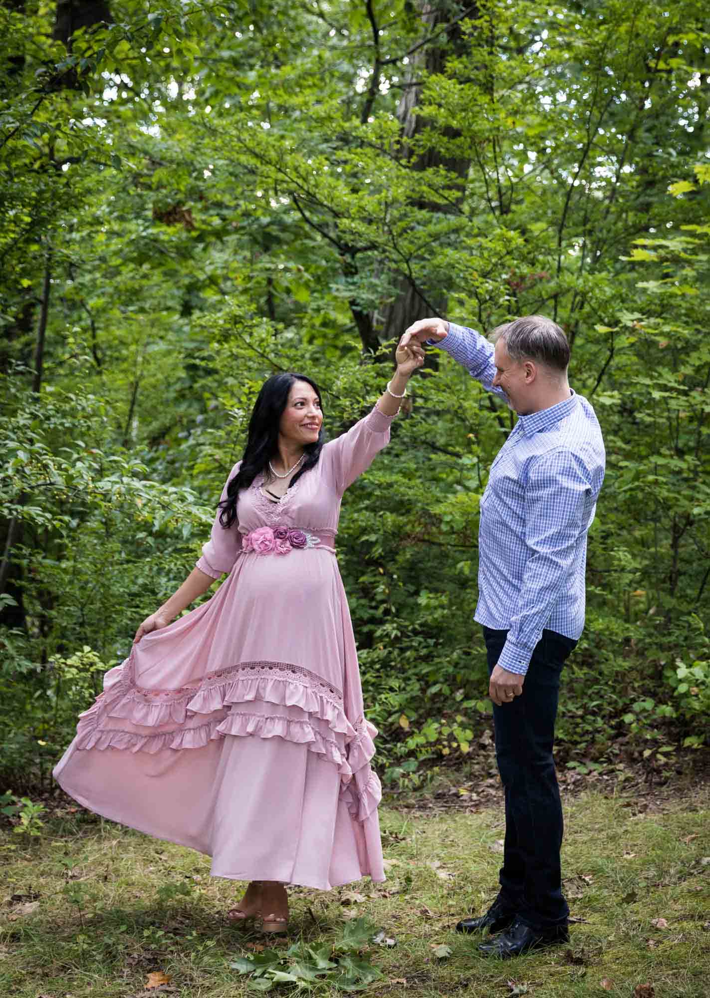 Forest Park maternity photos of a couple dancing in a forest