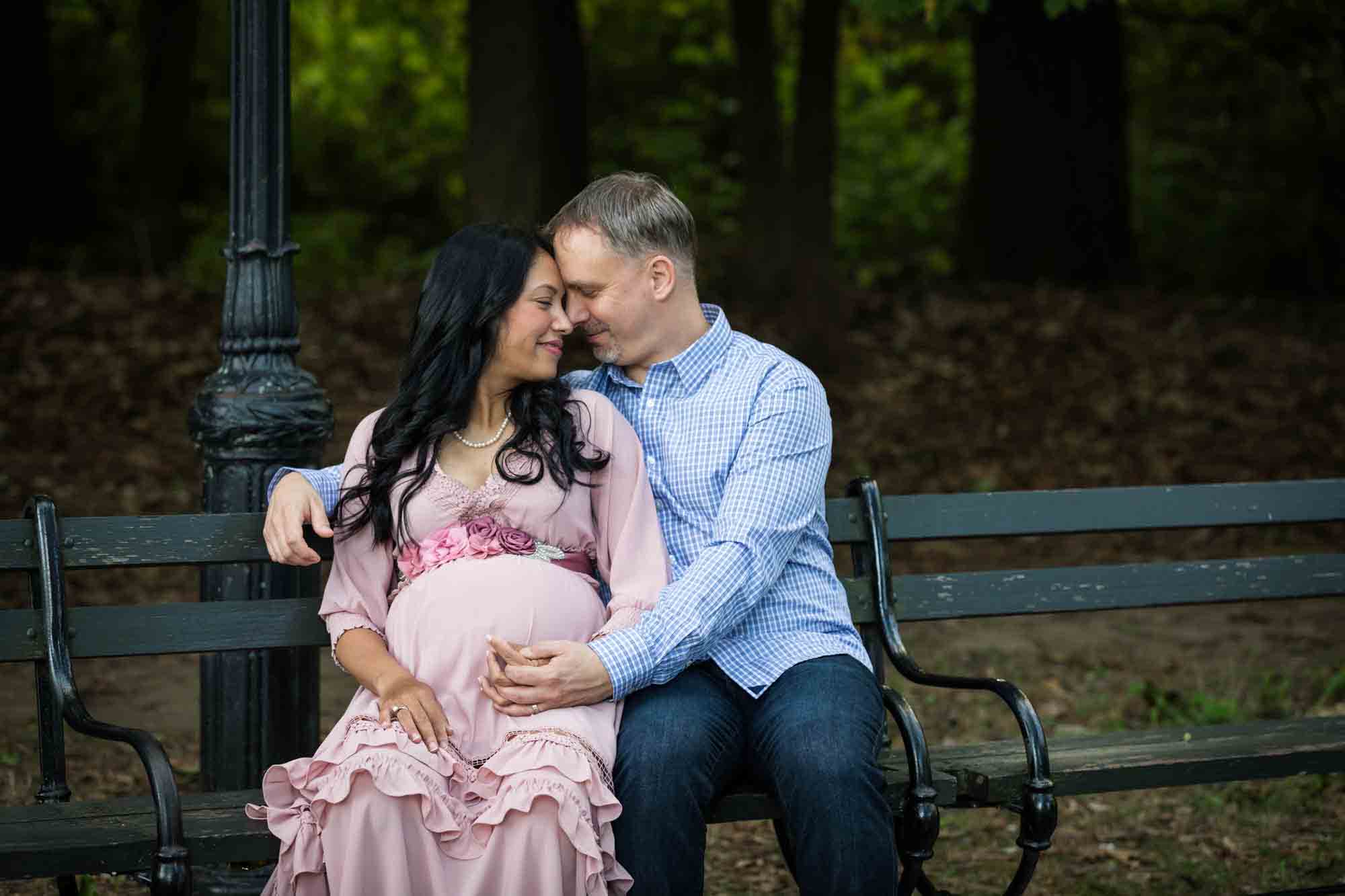 Forest Park maternity photos of couple sitting on a bench