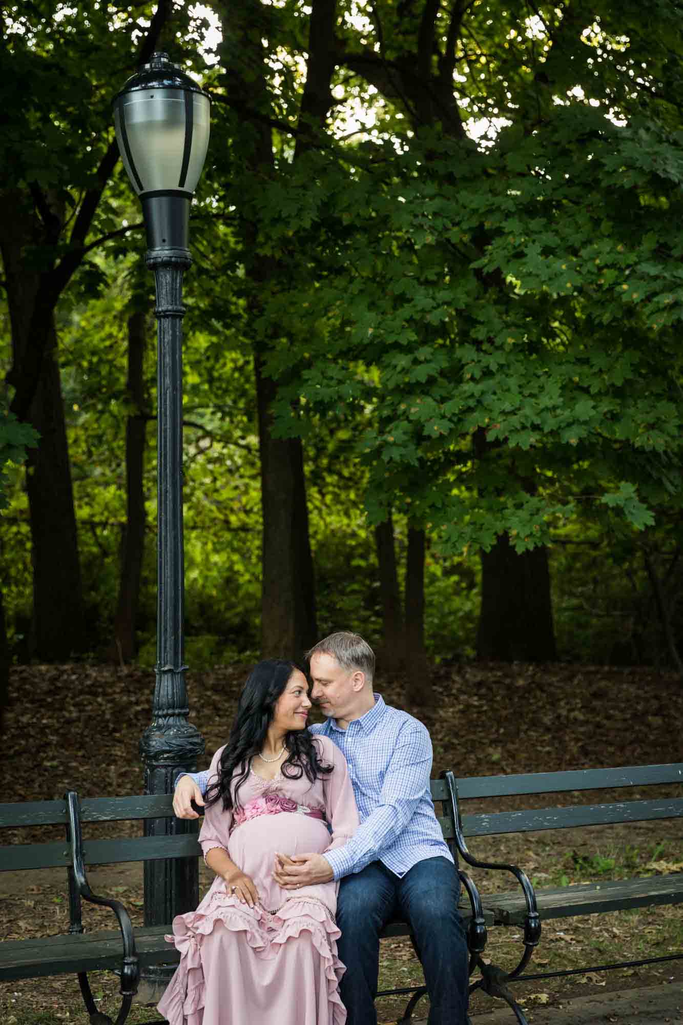 Forest Park maternity photos of couple sitting on a bench