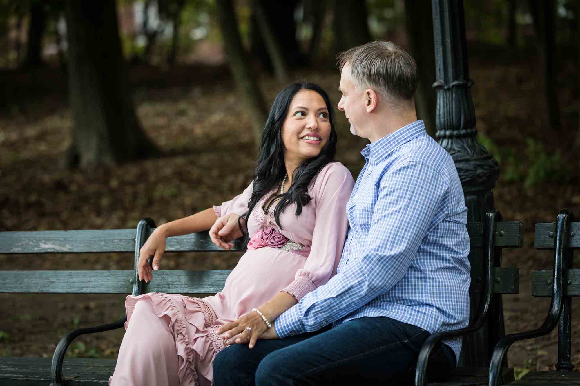 Forest Park maternity photos of couple sitting on a bench