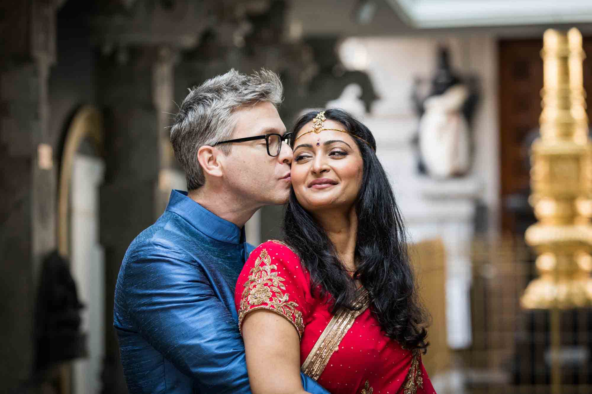 Ganesha Temple wedding photos of groom kissing bride's cheek