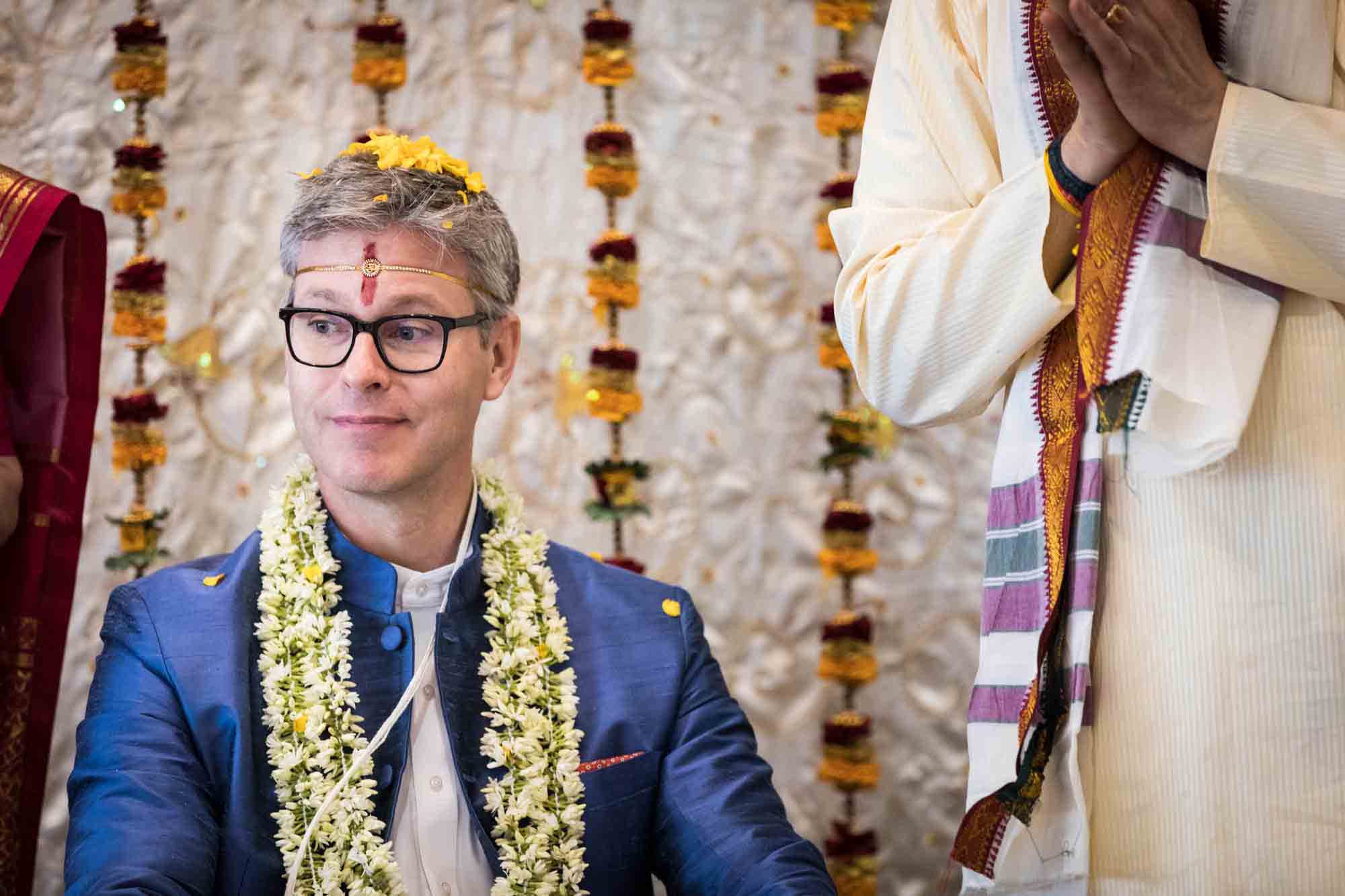 Flushing Temple wedding photos of groom wearing flower garlands