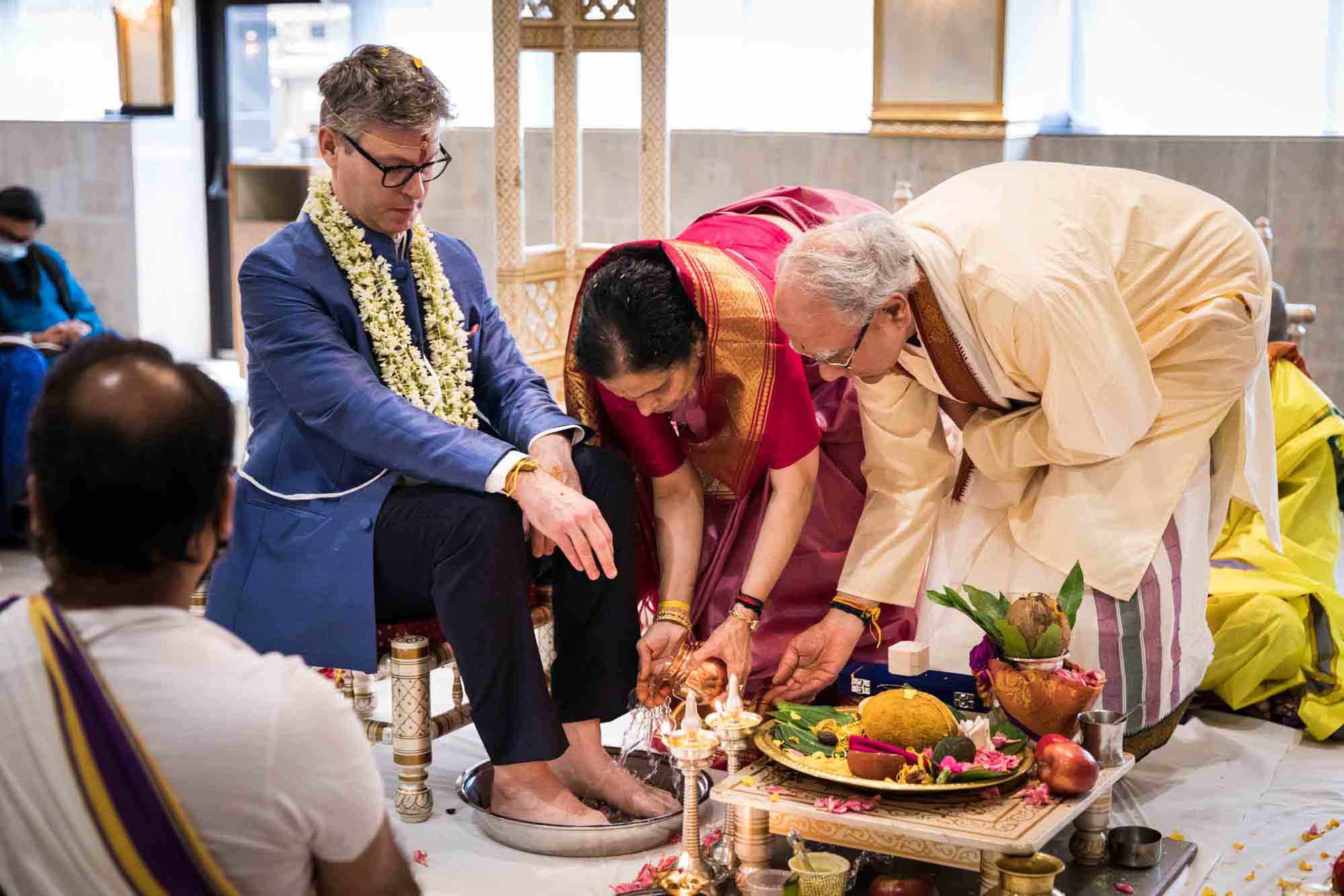 Flushing Temple wedding photos of bride's family washing groom's feet
