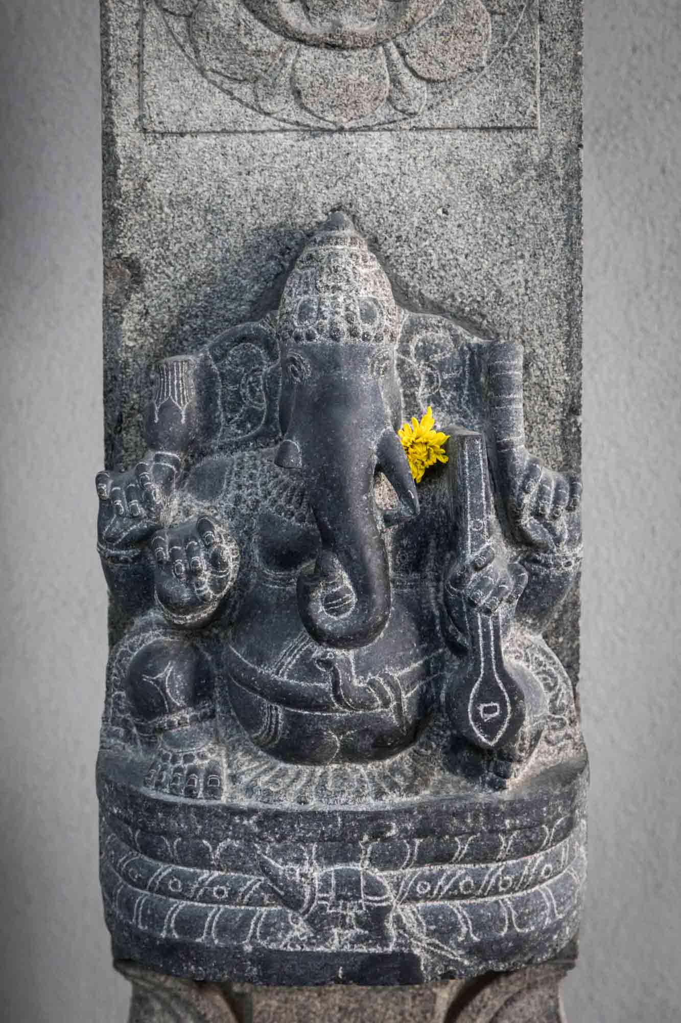 Ganesh elephant statue with yellow flower at the Hindu Temple Society of North America