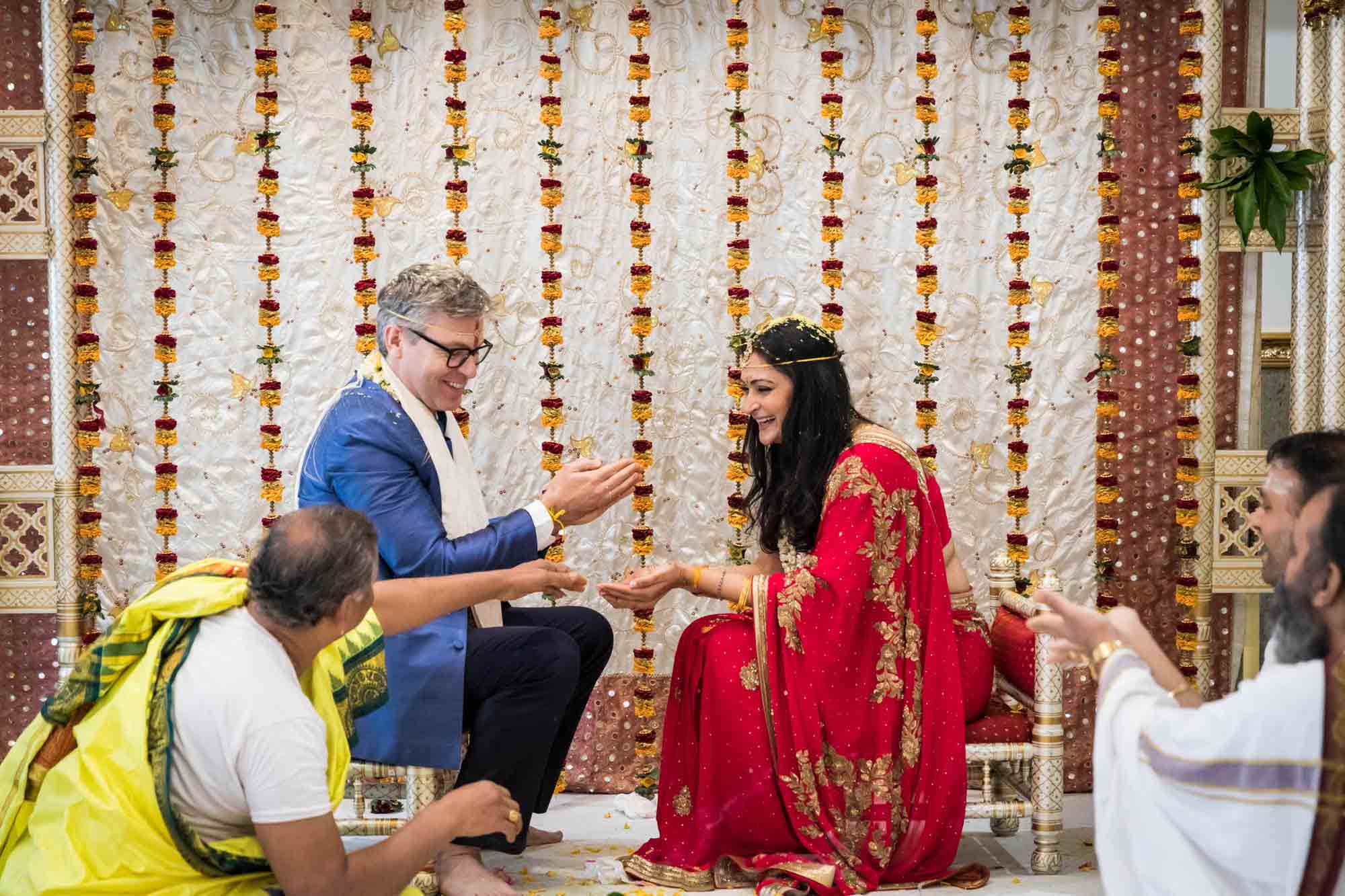 Bride and groom laughing at a Hindu Temple Society of North America wedding