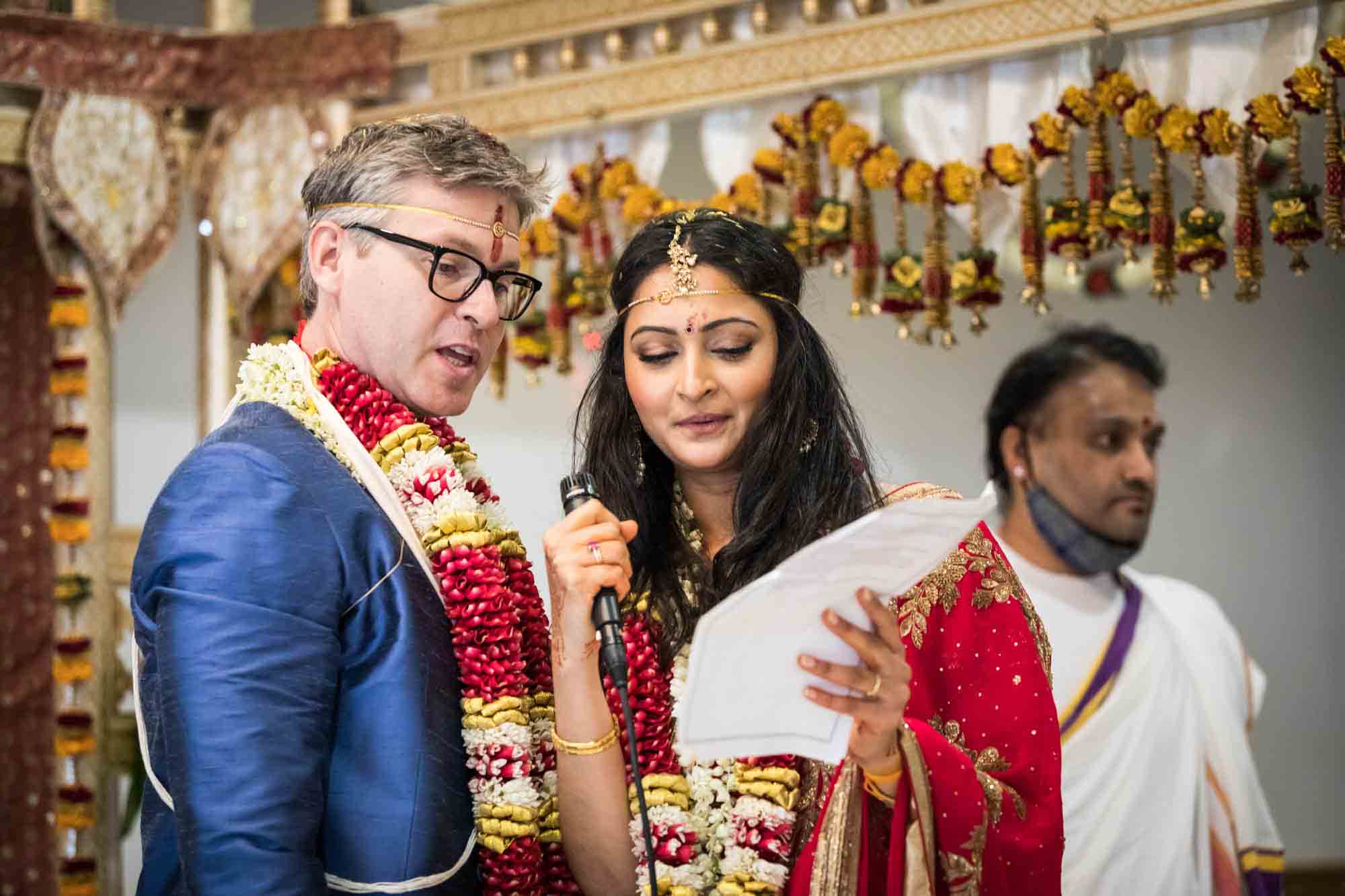 Bride and groom speaking at a Ganesha Temple wedding