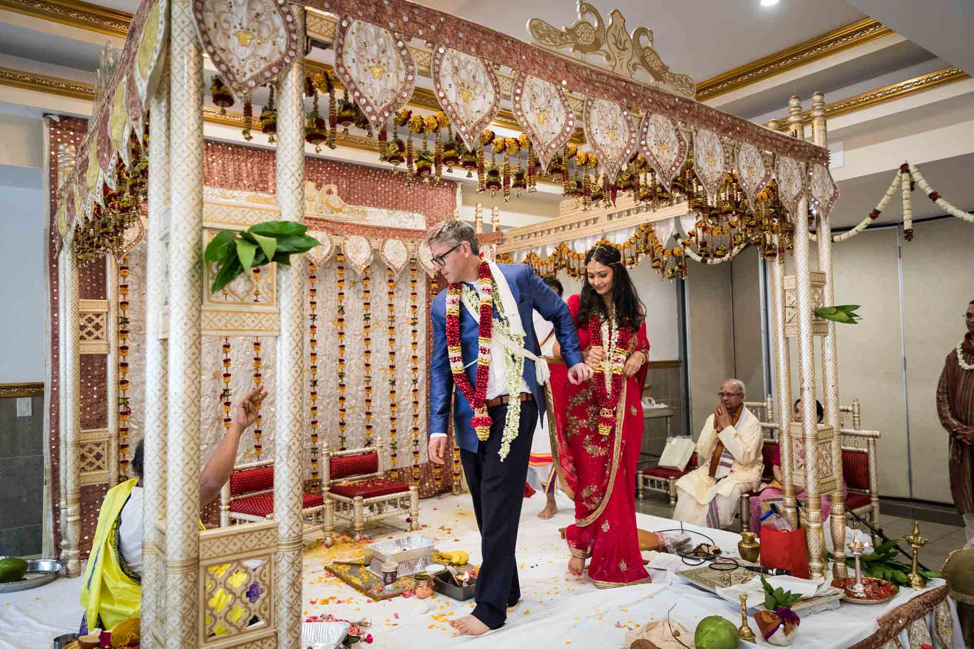 Bride and groom walking around altar at a Ganesha Temple wedding