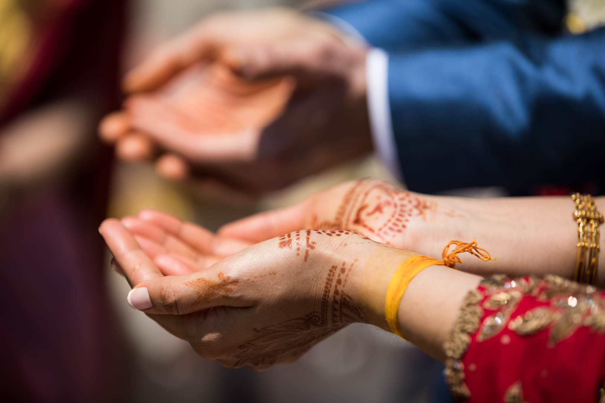 Hindu Temple Society of North America wedding photos of woman's hands painted in henna with man's hands behind her