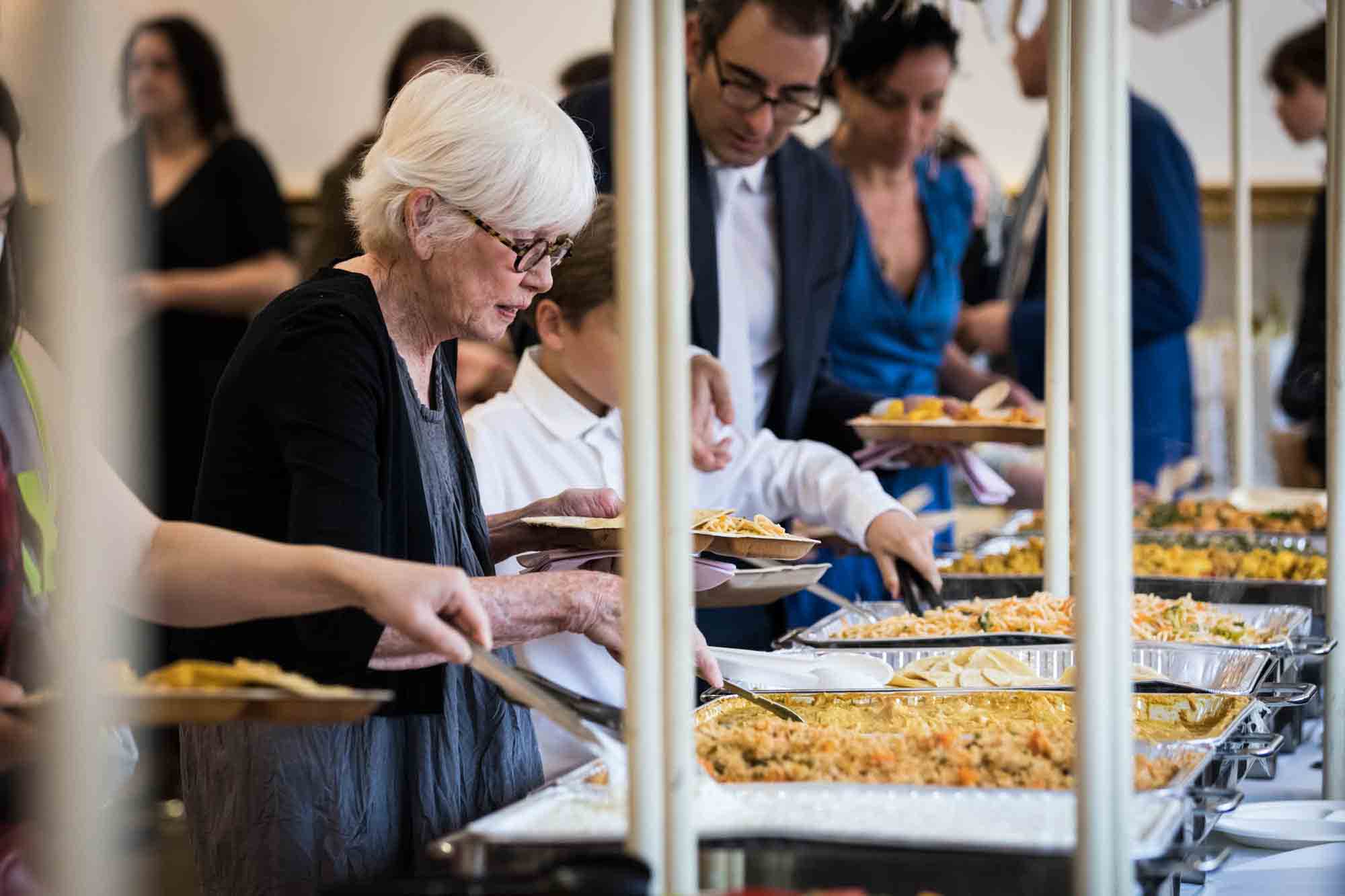 Hindu Temple Society of North America wedding photos of guests selecting food from canteen buffet