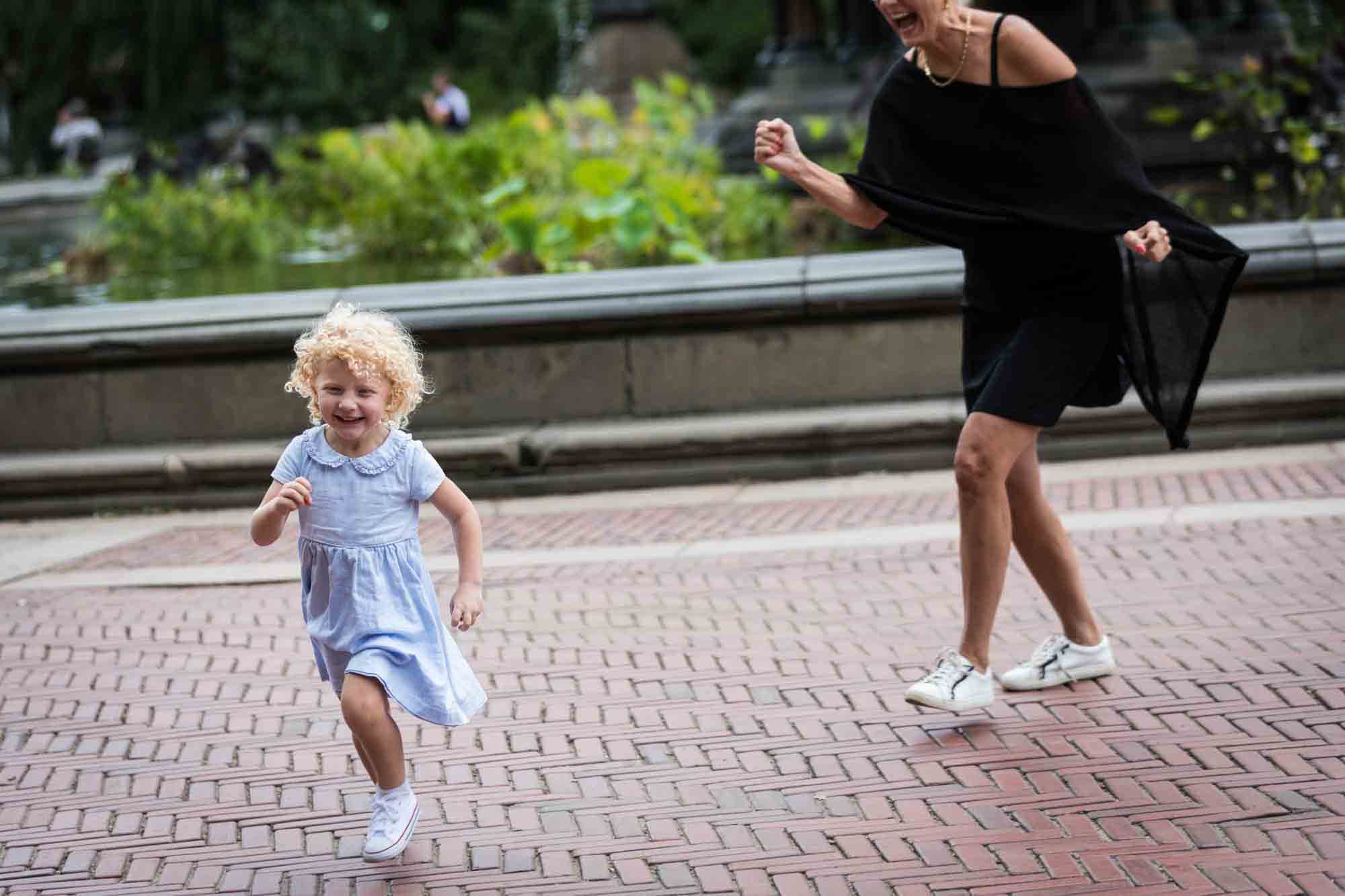 Grandmother chasing little blonde girl for an article on NYC family portrait tips for tourists