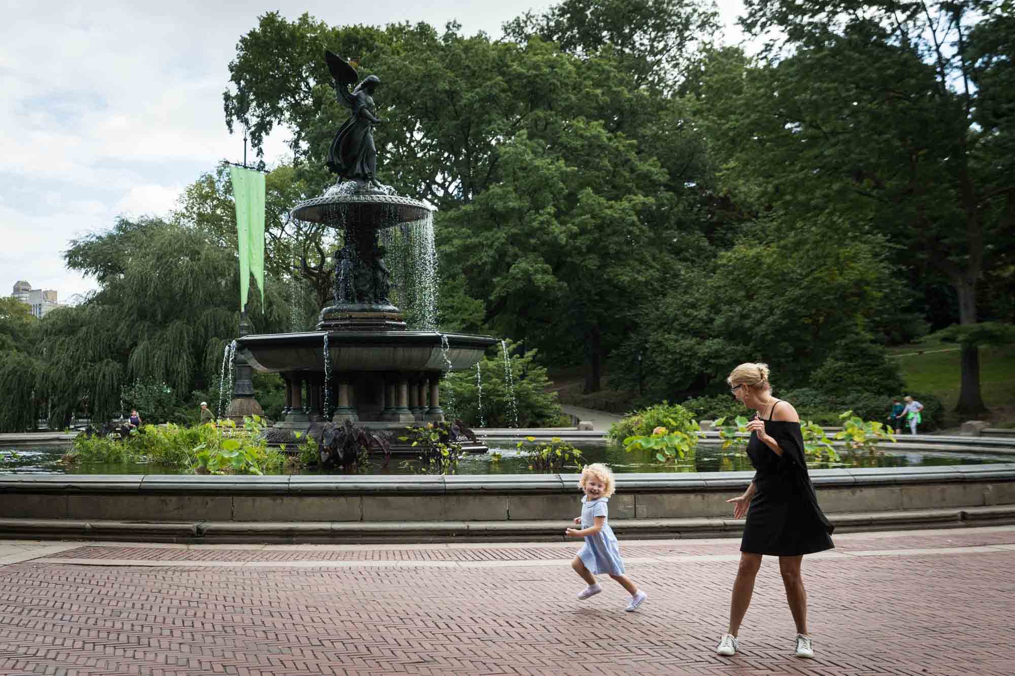 Grandmother and little blonde girl in front of Bethesda Fountain for an article on NYC family portrait tips for tourists