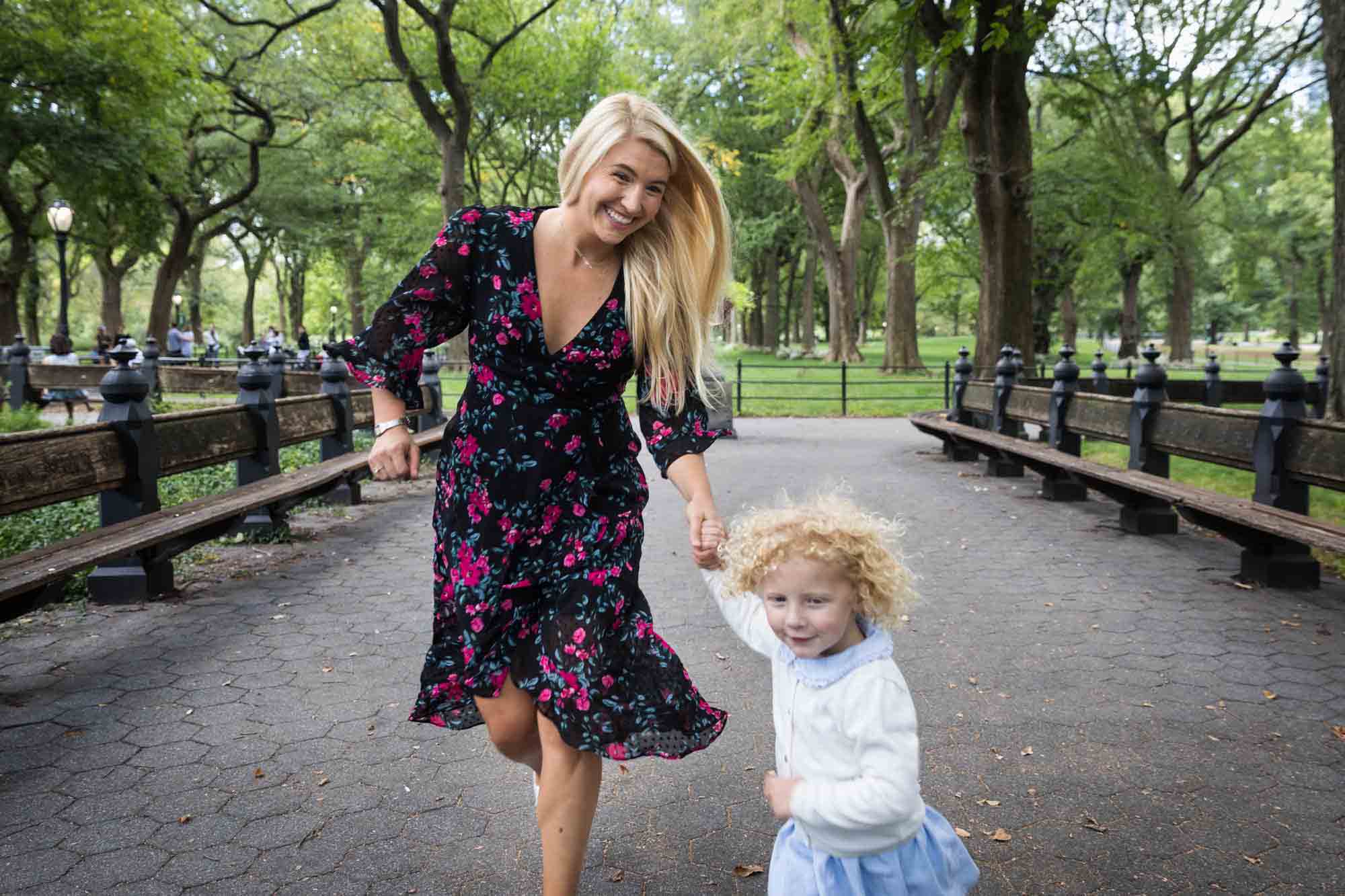 Mother and child running in Central Park for an article on NYC family portrait tips for tourists