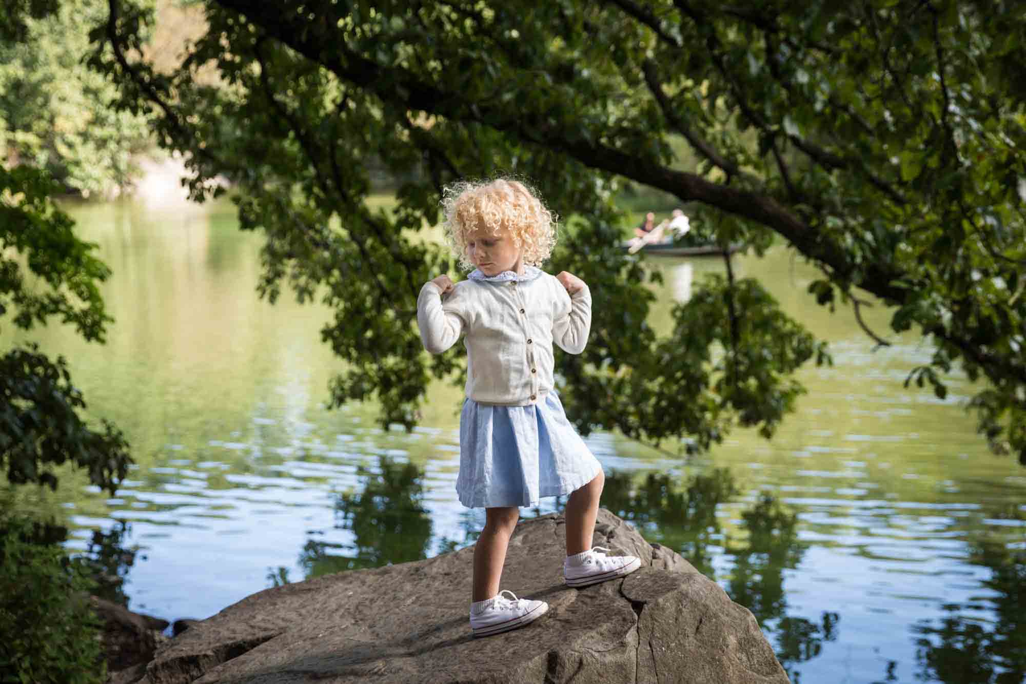 Central Park family portrait of little girl standing on stone