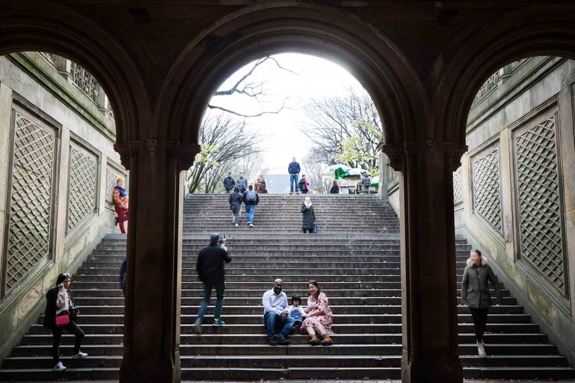 Central Park family portrait of family sitting on steps of Bethesda Terrace