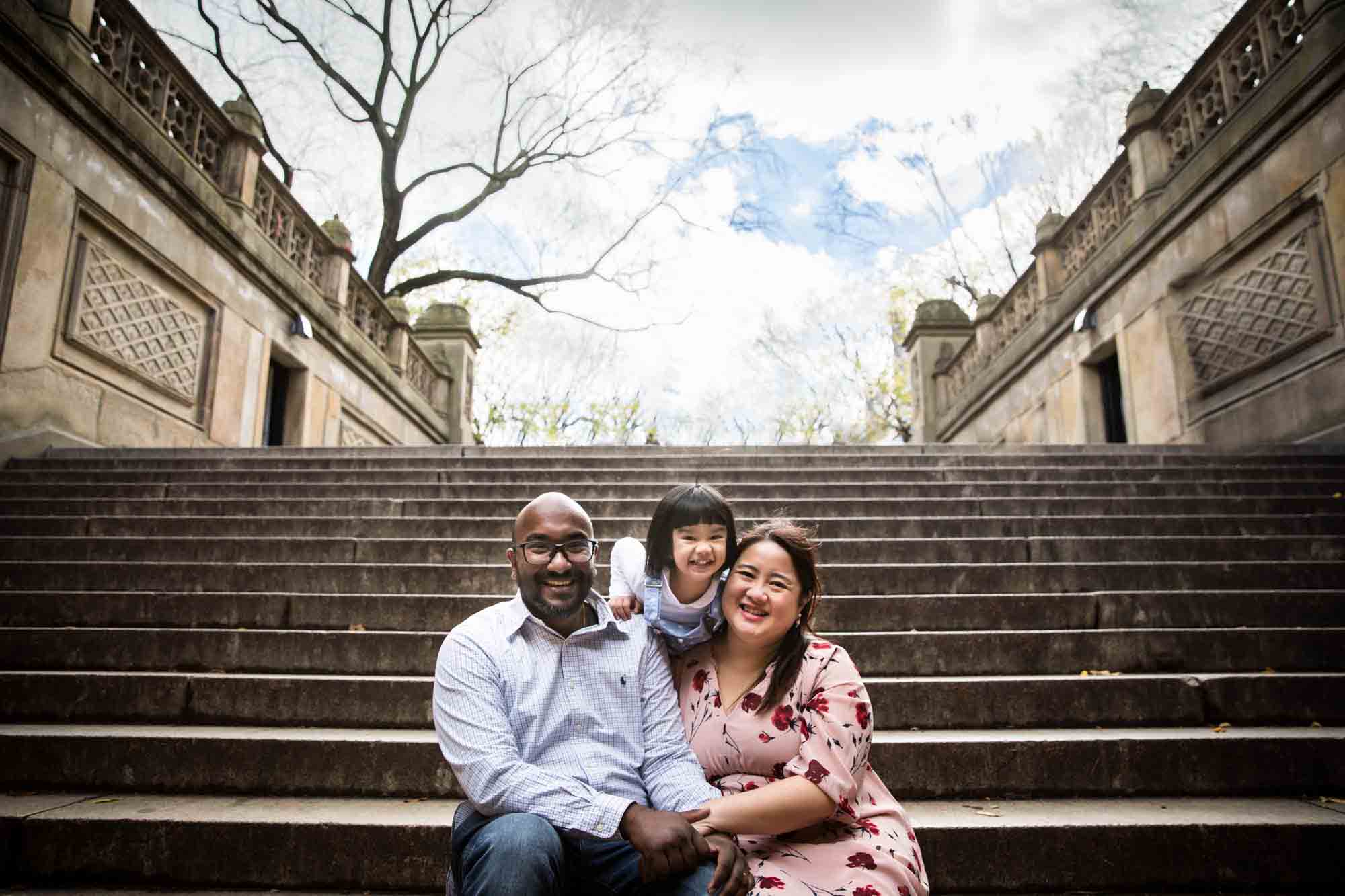 Central Park family portrait of family sitting on steps of Bethesda Terrace