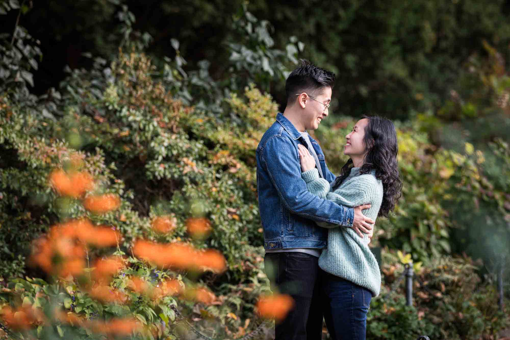 Fort Tryon Park engagement photo of couple hugging in Heather Garden