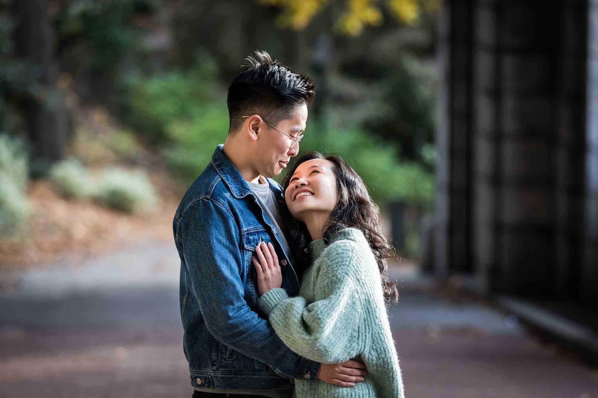 Fort Tryon Park engagement photos of couple looking at each other under Billings Arcade
