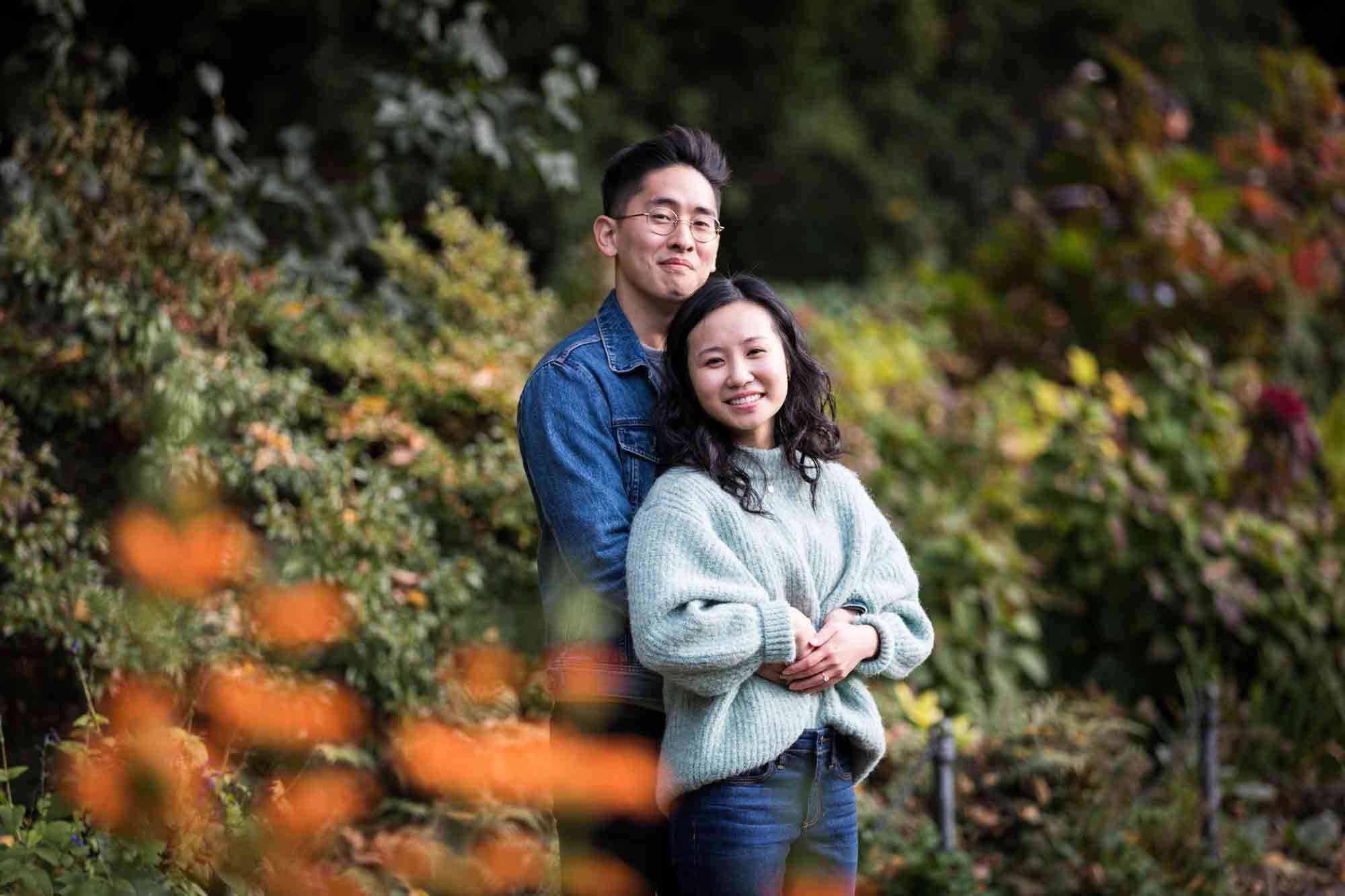 Fort Tryon Park engagement photos of couple hugging in middle of Heather Garden