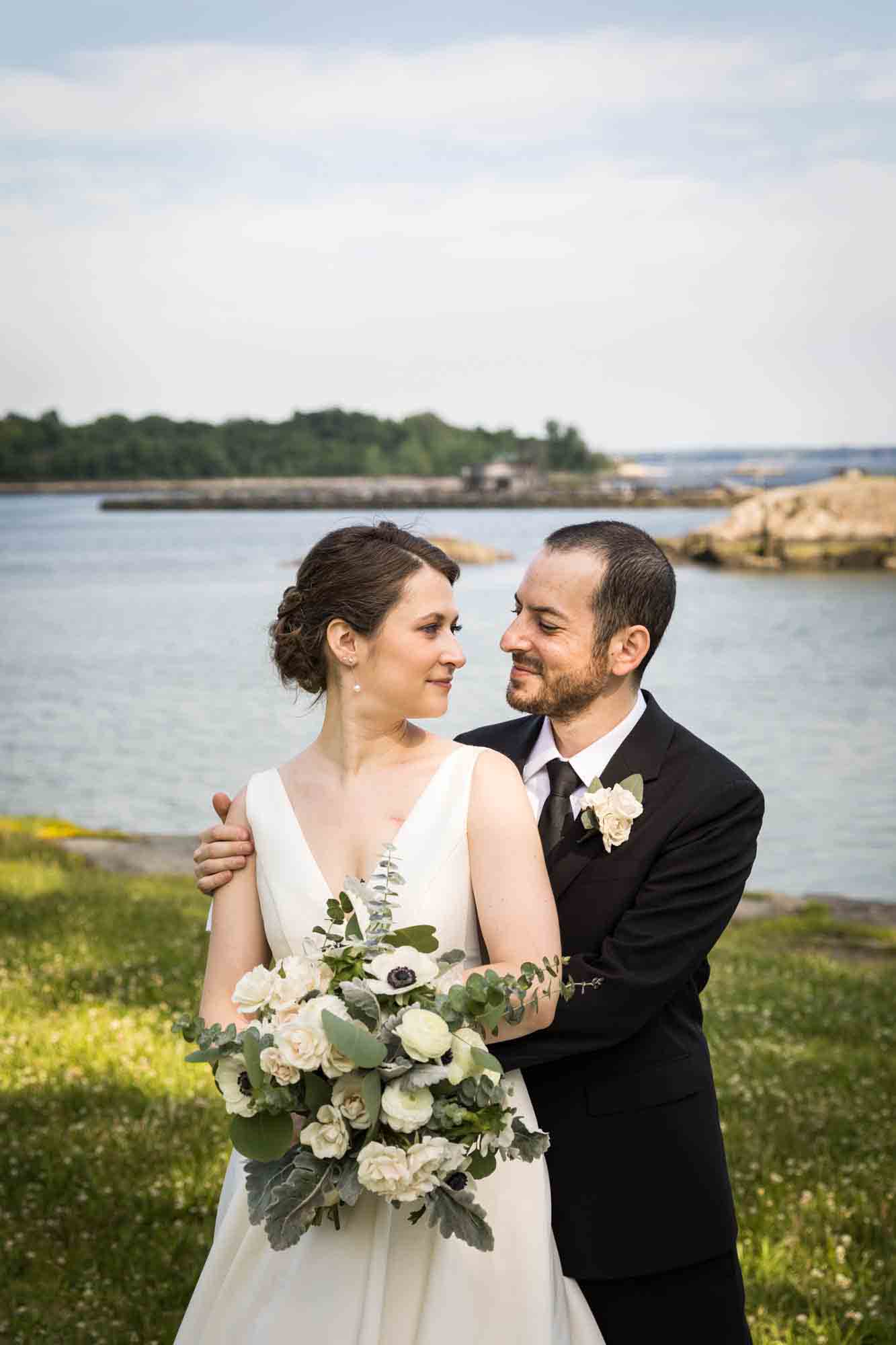 Glen Island Harbour Club wedding photos of bride and groom looking at each other in front of Long Island Sound