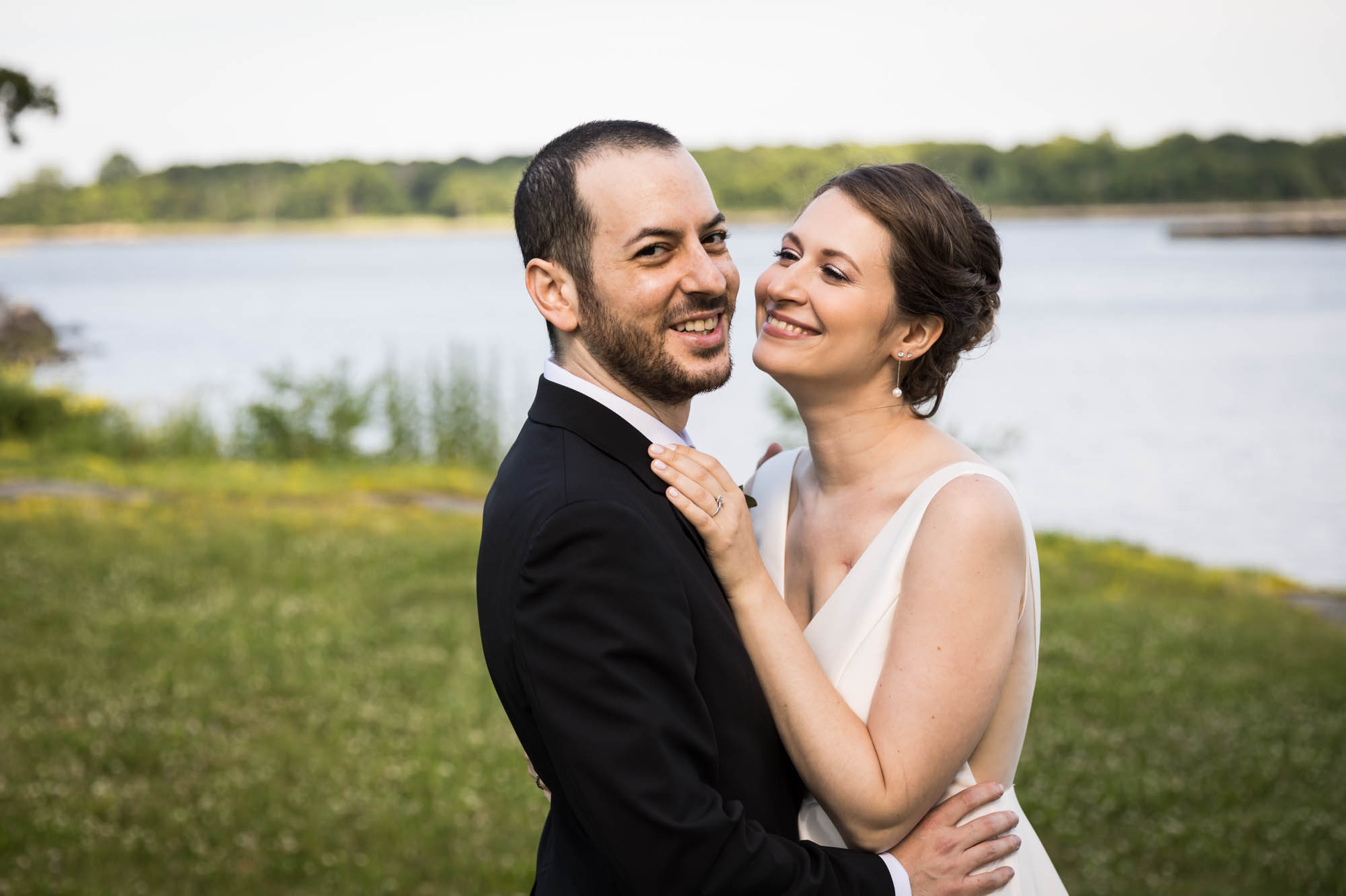 Glen Island Harbour Club wedding photos of bride and groom in front of grass and waterfront