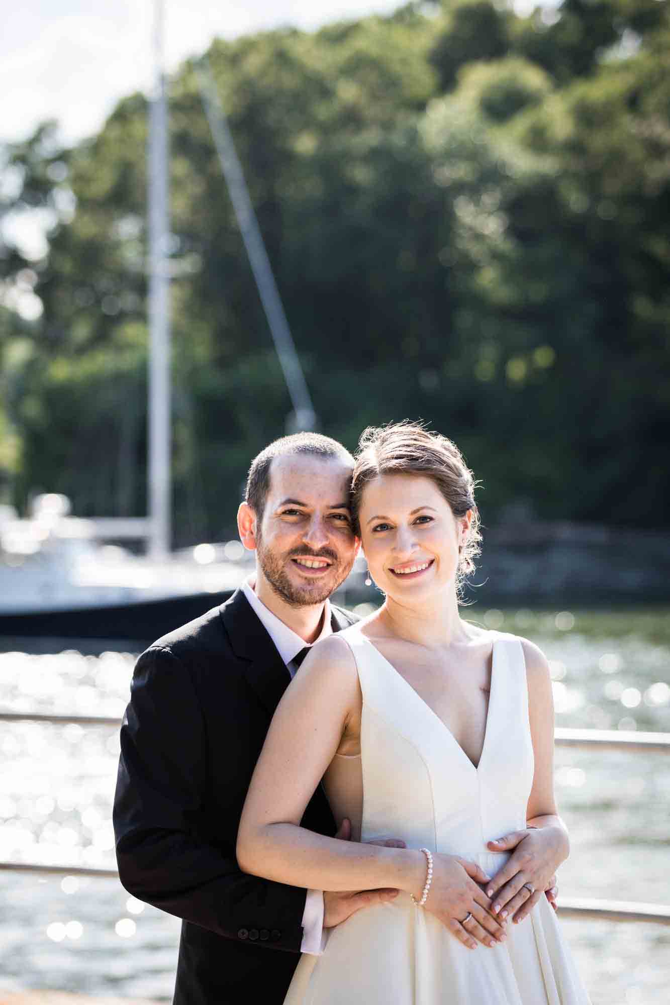 Glen Island Park wedding photos of bride and groom in front of water and sailboat