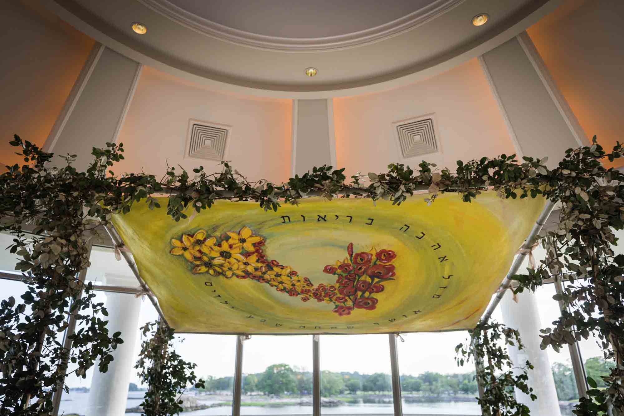 Hand-painted chuppah in front of windows at Glen Island Harbour Club