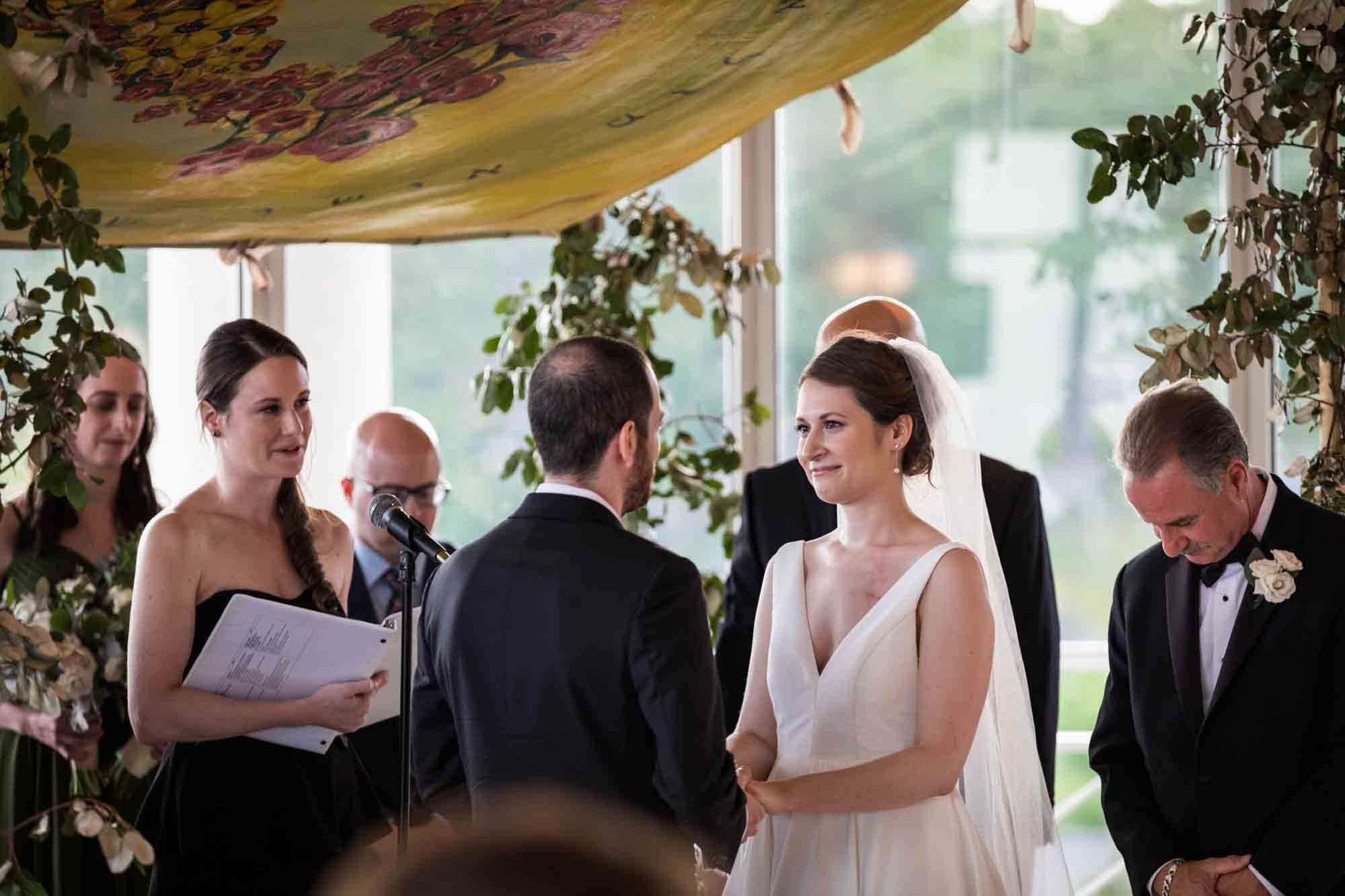 Bride and groom exchanging vows under chuppah at a Glen Island Harbour Club wedding