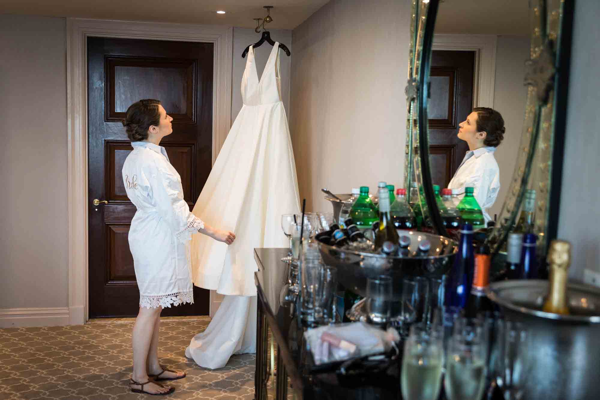 Glen Island Harbour Club wedding photos of bride looking at dress reflected in mirror