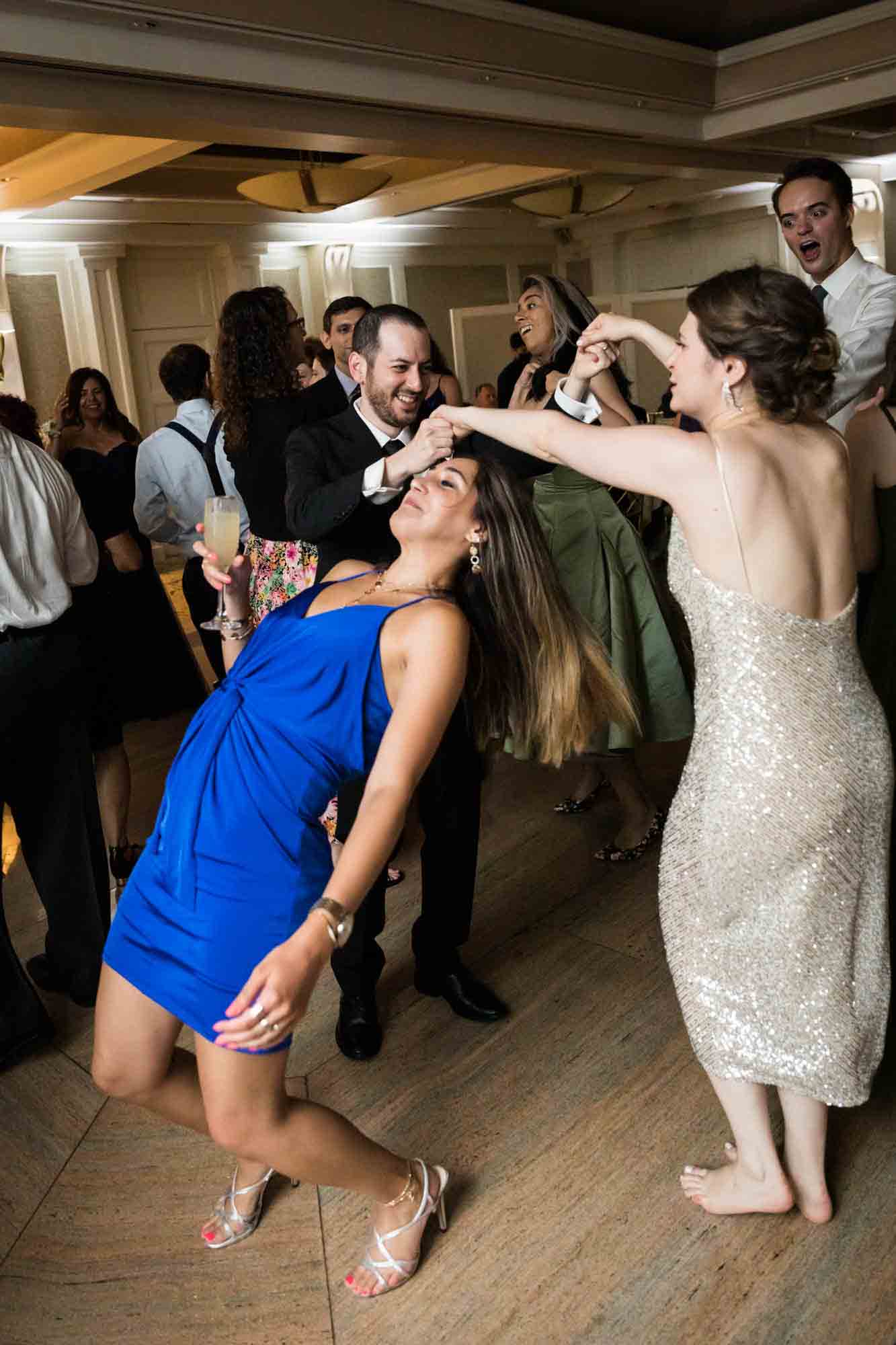 Bride and groom dancing with woman in blue dress at a Glen Island Harbour Club wedding