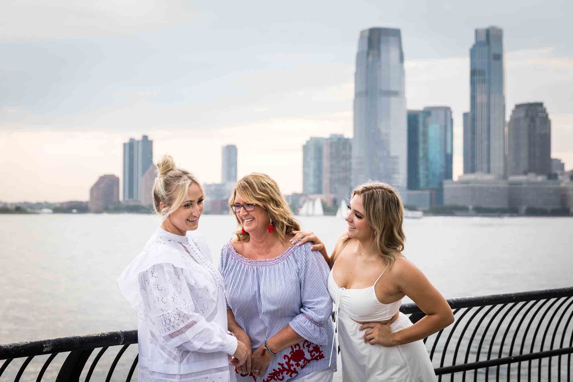 Mother and two daughters laughing in front of New Jersey skyline