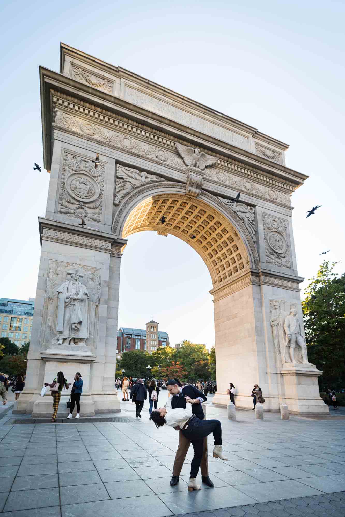 Couple dancing under Washington Square Park arch