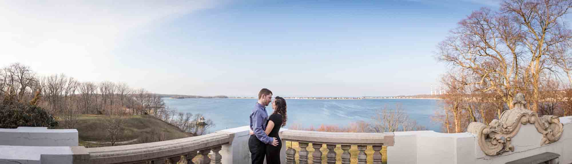 Panorama photo of couple on terrace overlooking Northport Bay