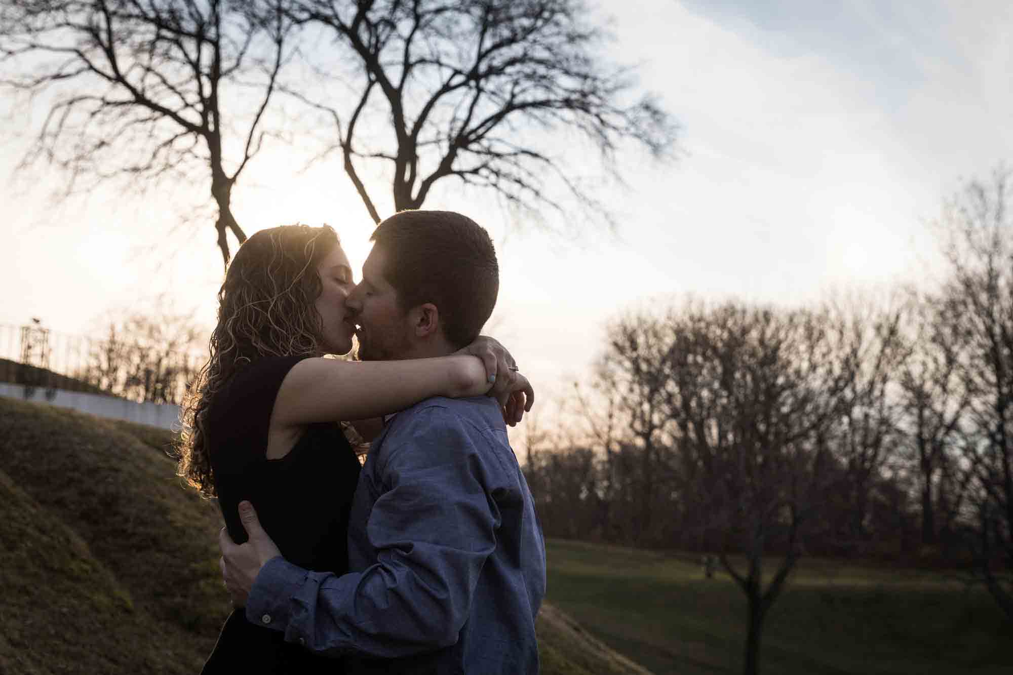 Silhouette photo of couple kissing at a Vanderbilt Museum engagement photo shoot