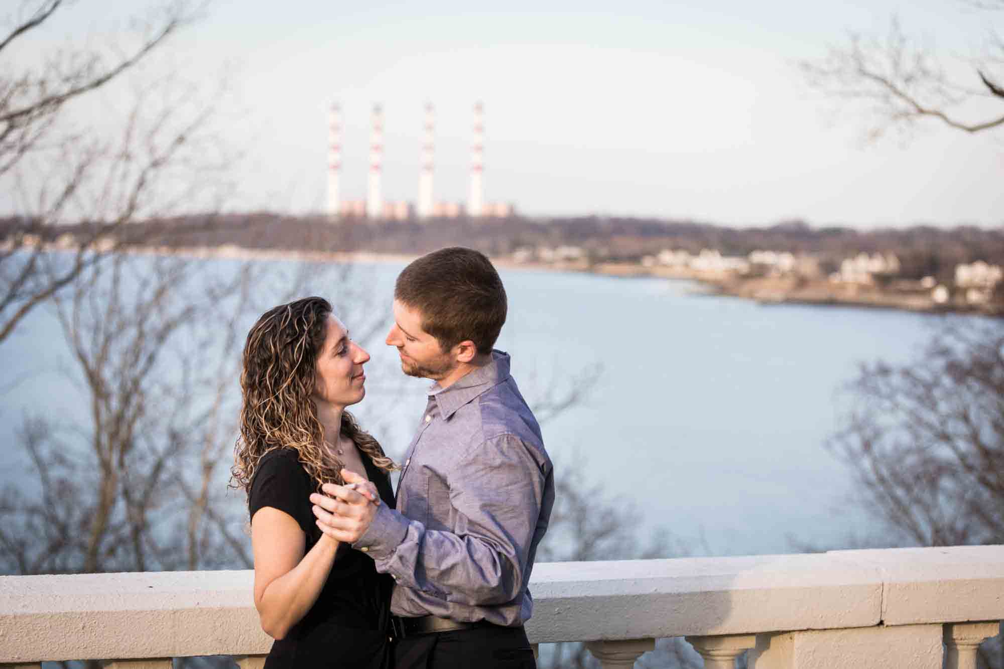 Vanderbilt Museum engagement photos of couple dancing on terrace overlooking Northport Bay