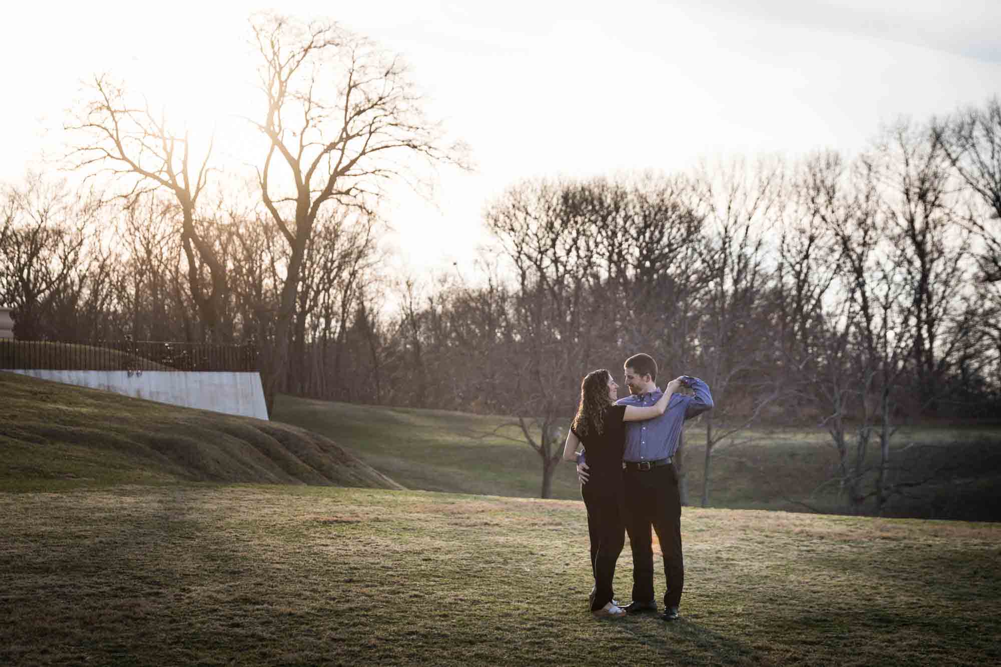 Vanderbilt Museum engagement photos of couple dancing in grass