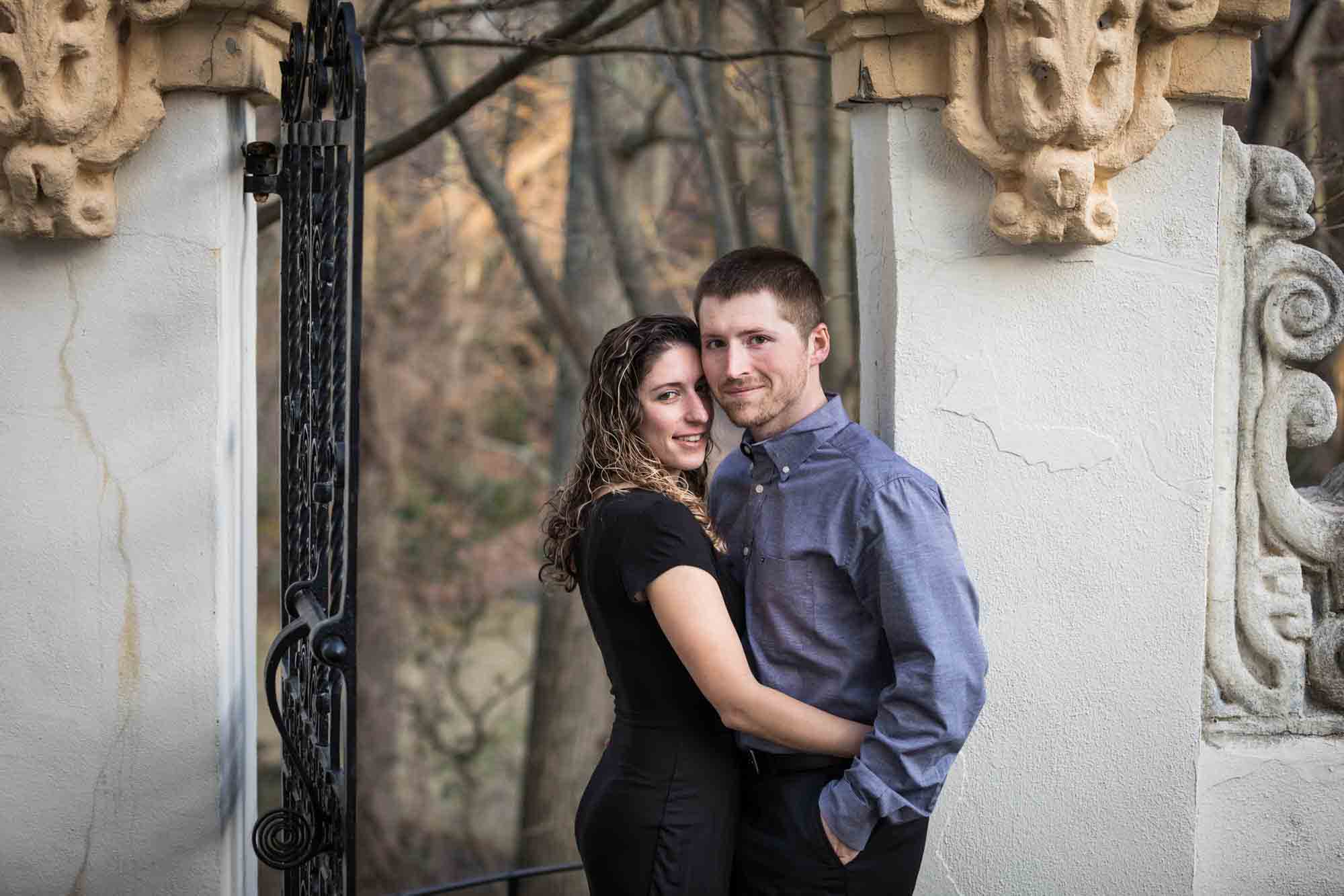 Vanderbilt Museum engagement photos of couple leaning against stone gate