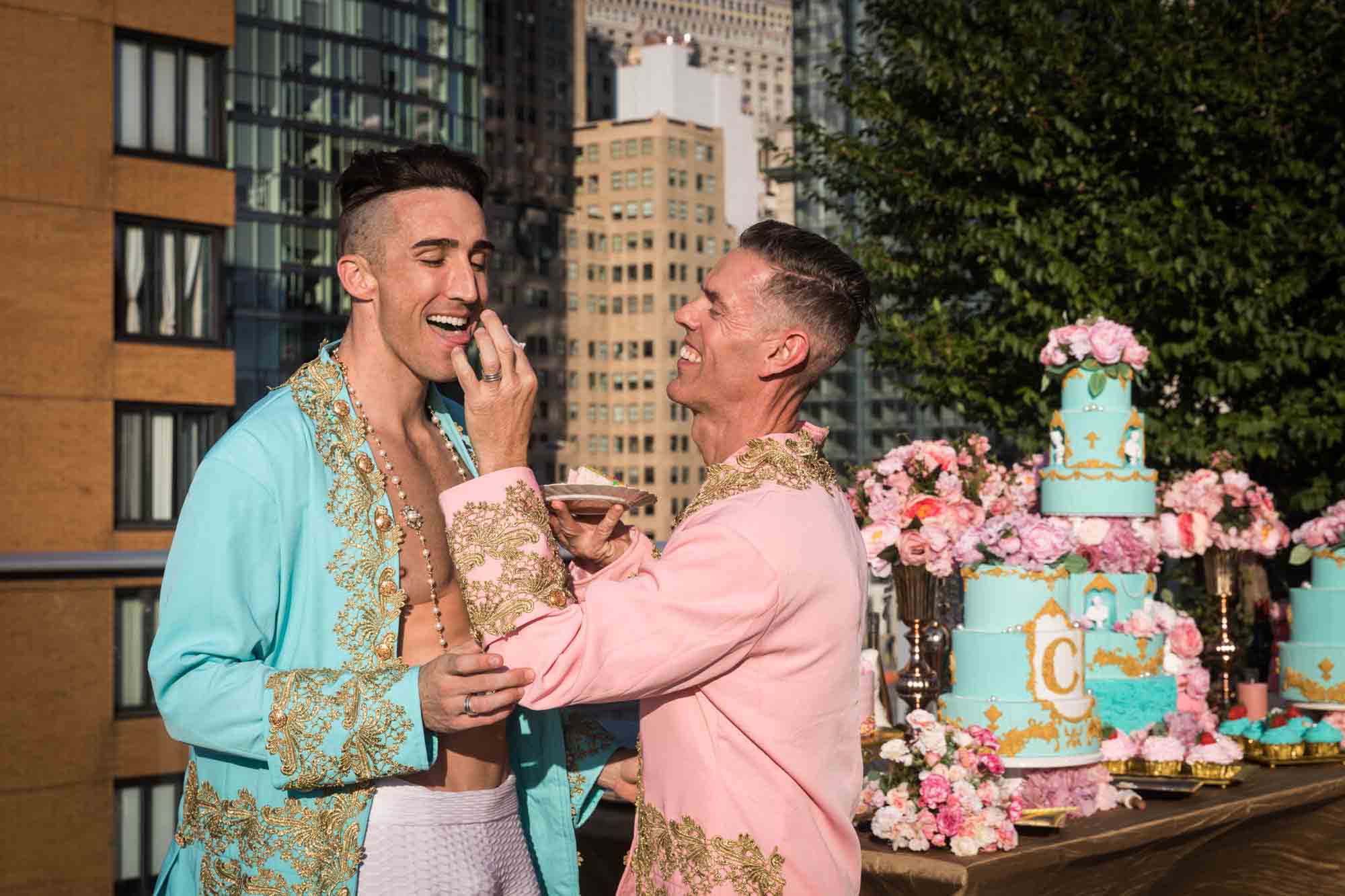 Man feeding another man while dressed as French courtier for an article on event planning photography tips