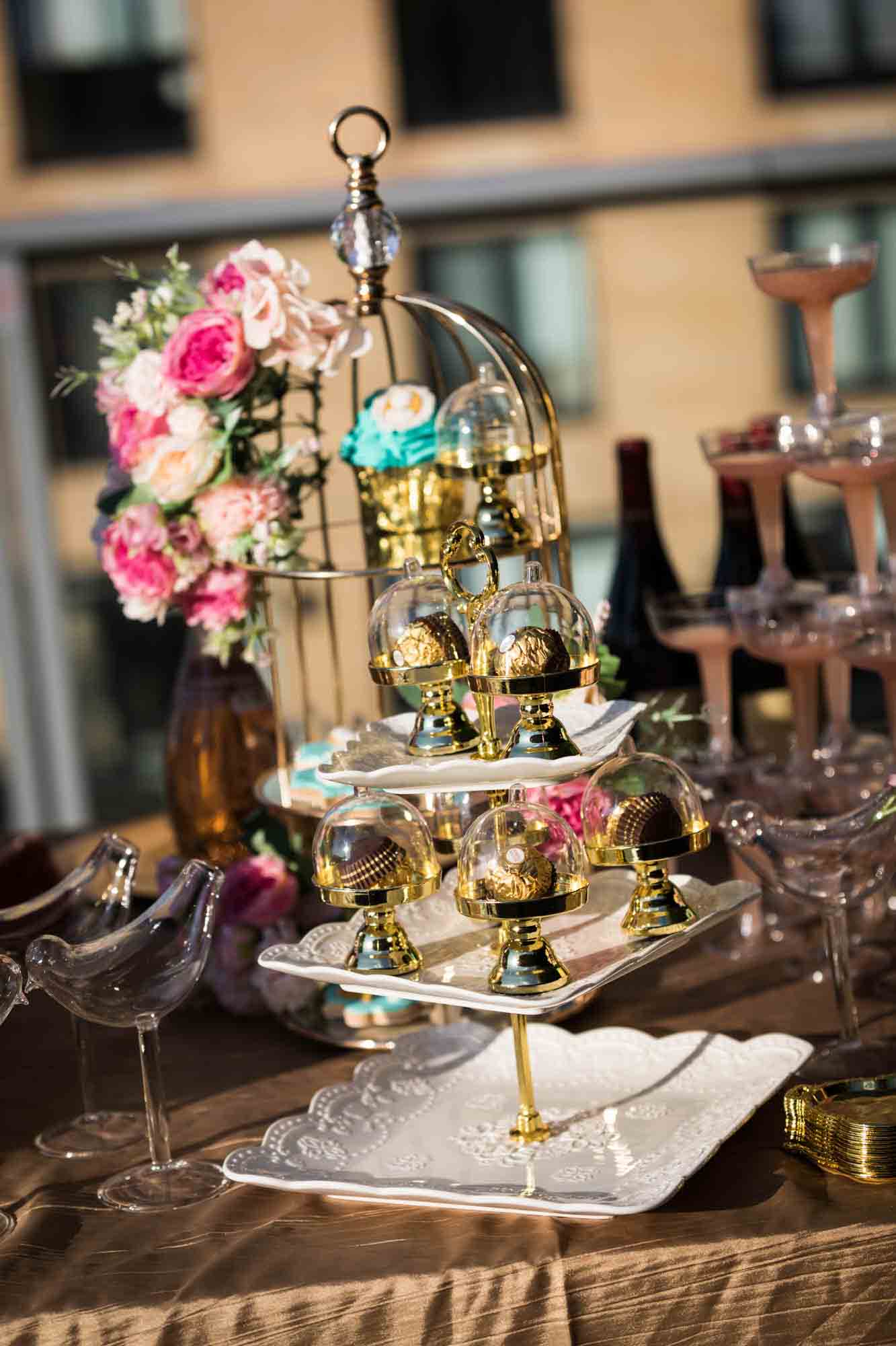 A table filled with elaborately-decorated desserts for a Marie Antoinette-themed party