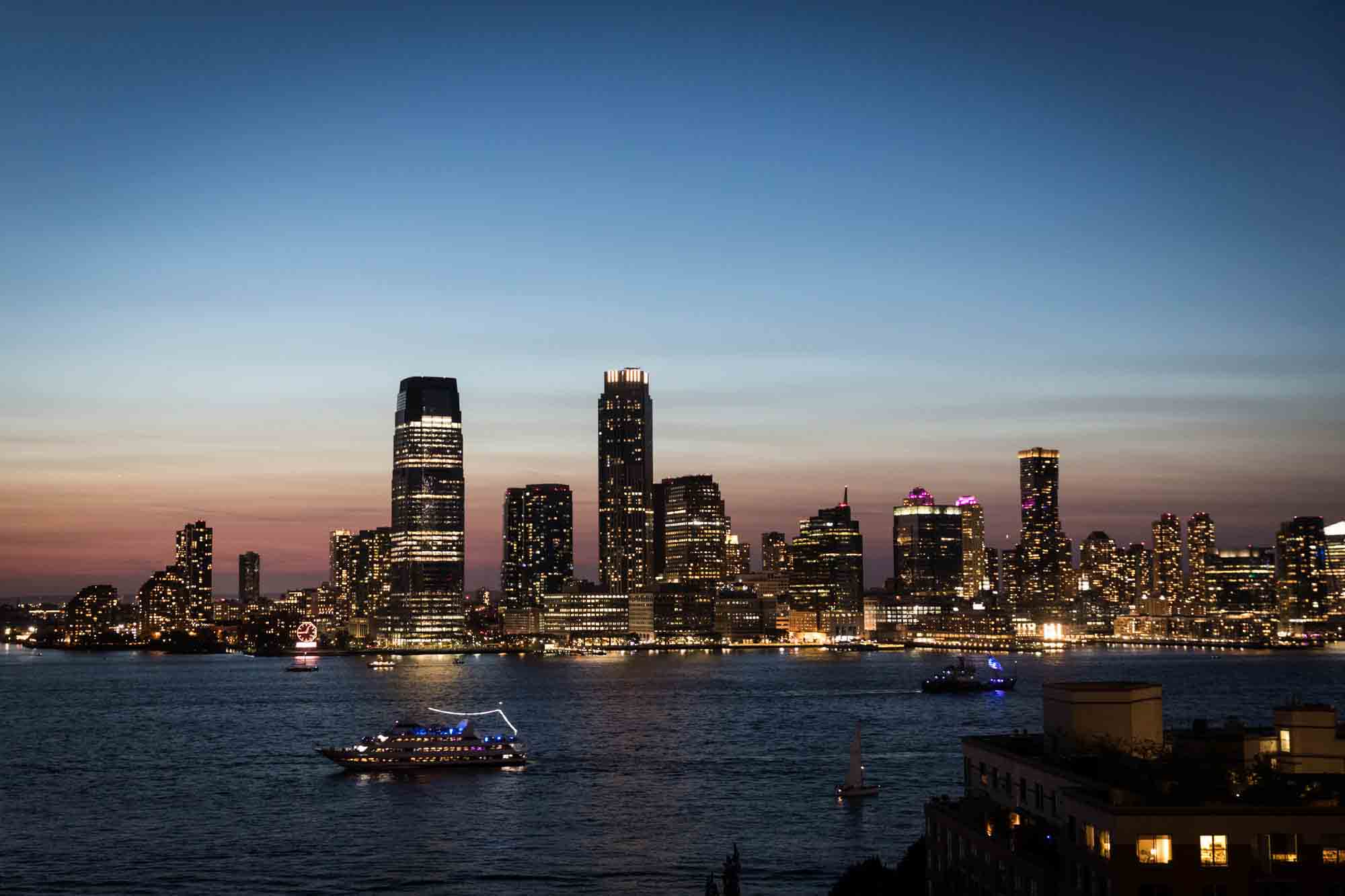 Sunset over the Hudson River with boat and skyscrapers