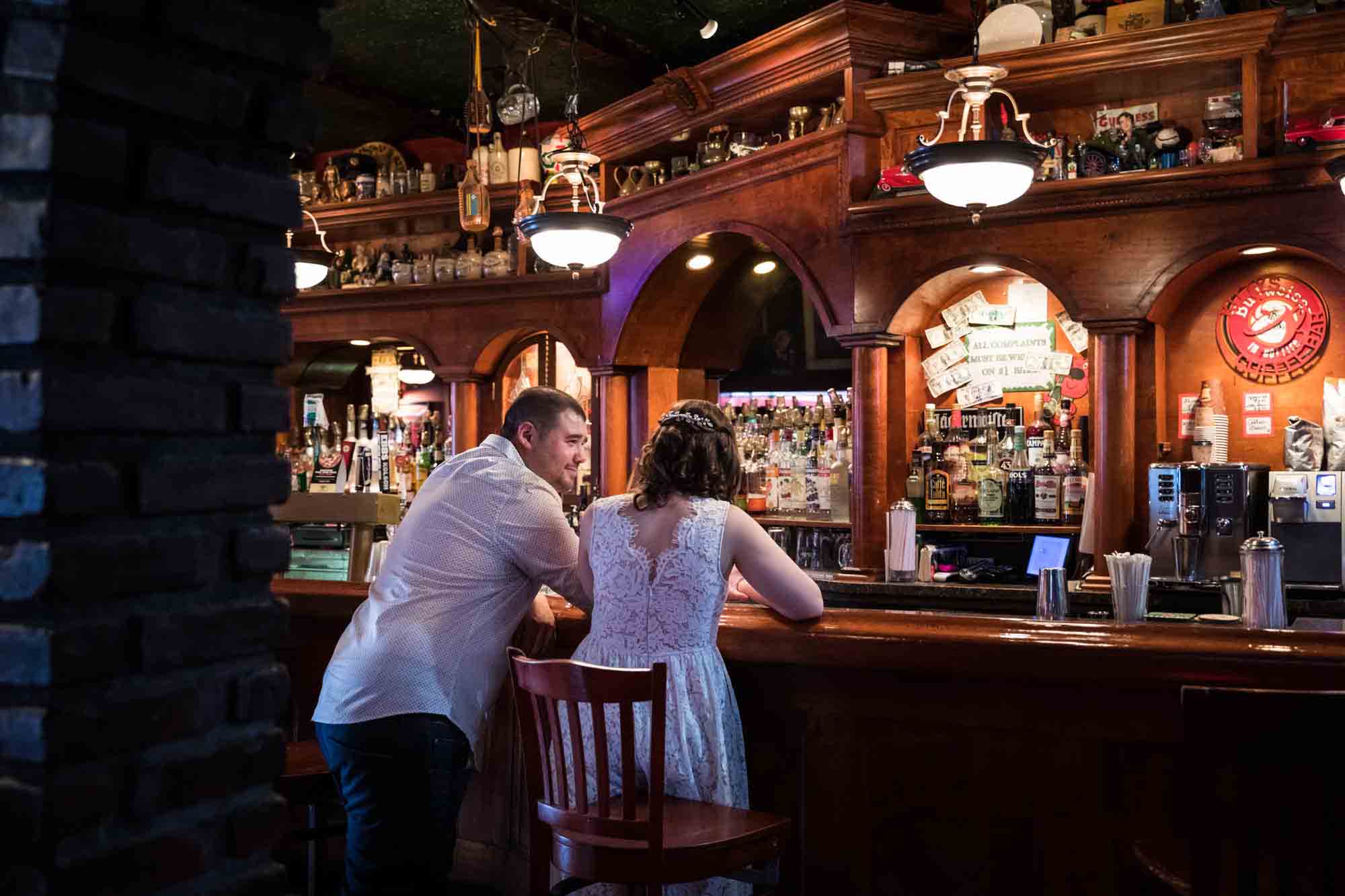 Couple sitting at bar talking for an article on how to recreate your love story in your engagement shoot