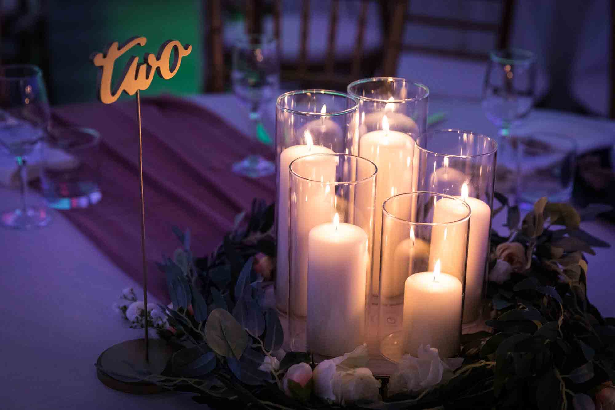 Lit candles and table numbers at Loft Story wedding