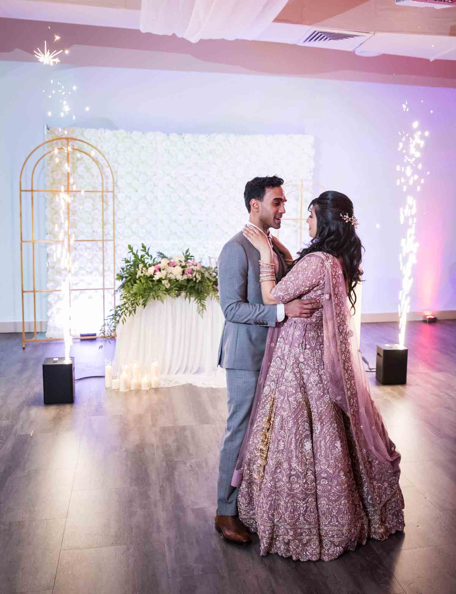 Indian bride and groom with sparklers during first dance at a Loft Story wedding