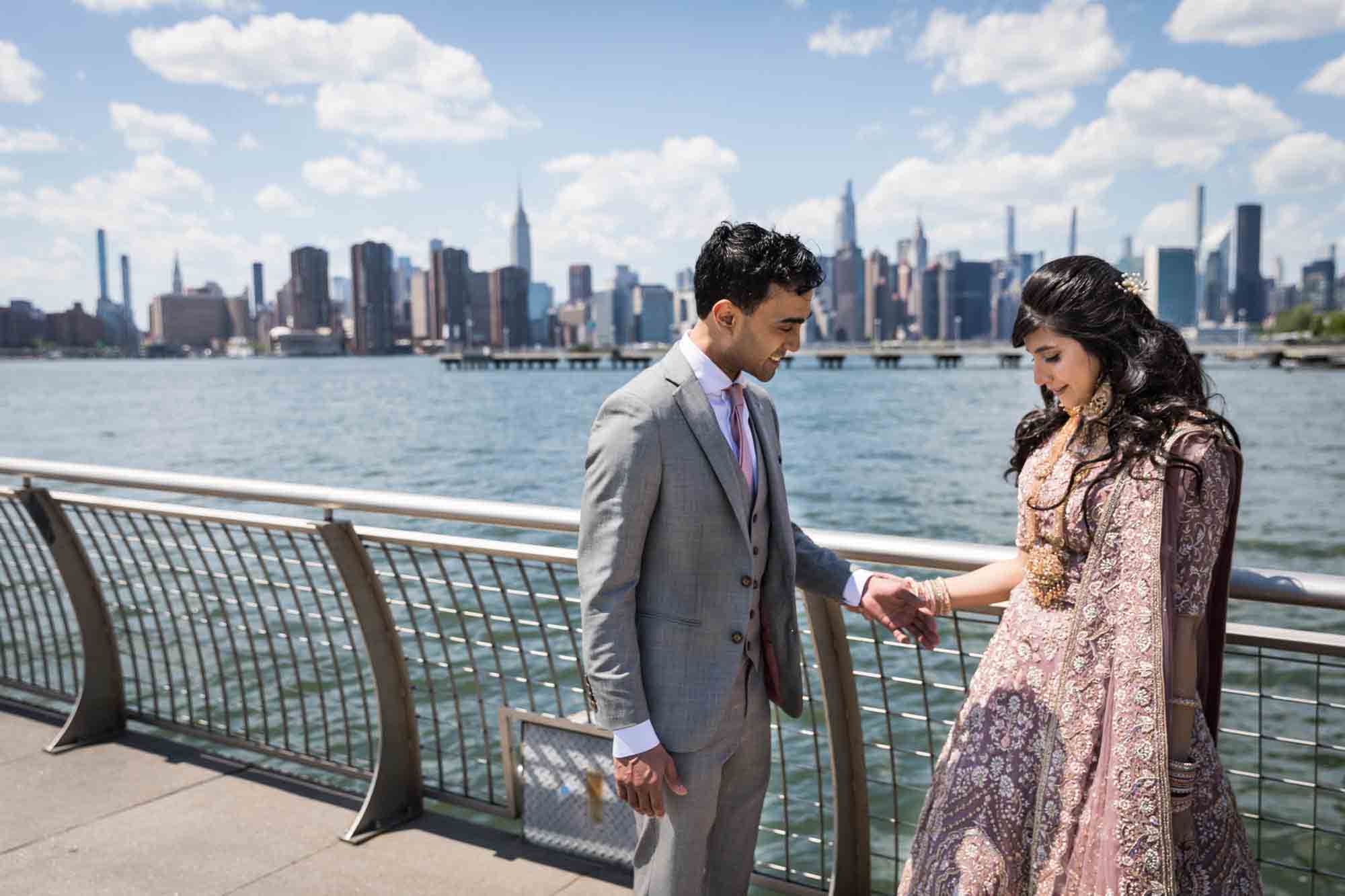 Bride and groom seeing each other during first look on dock at WNYC Transmitter Park